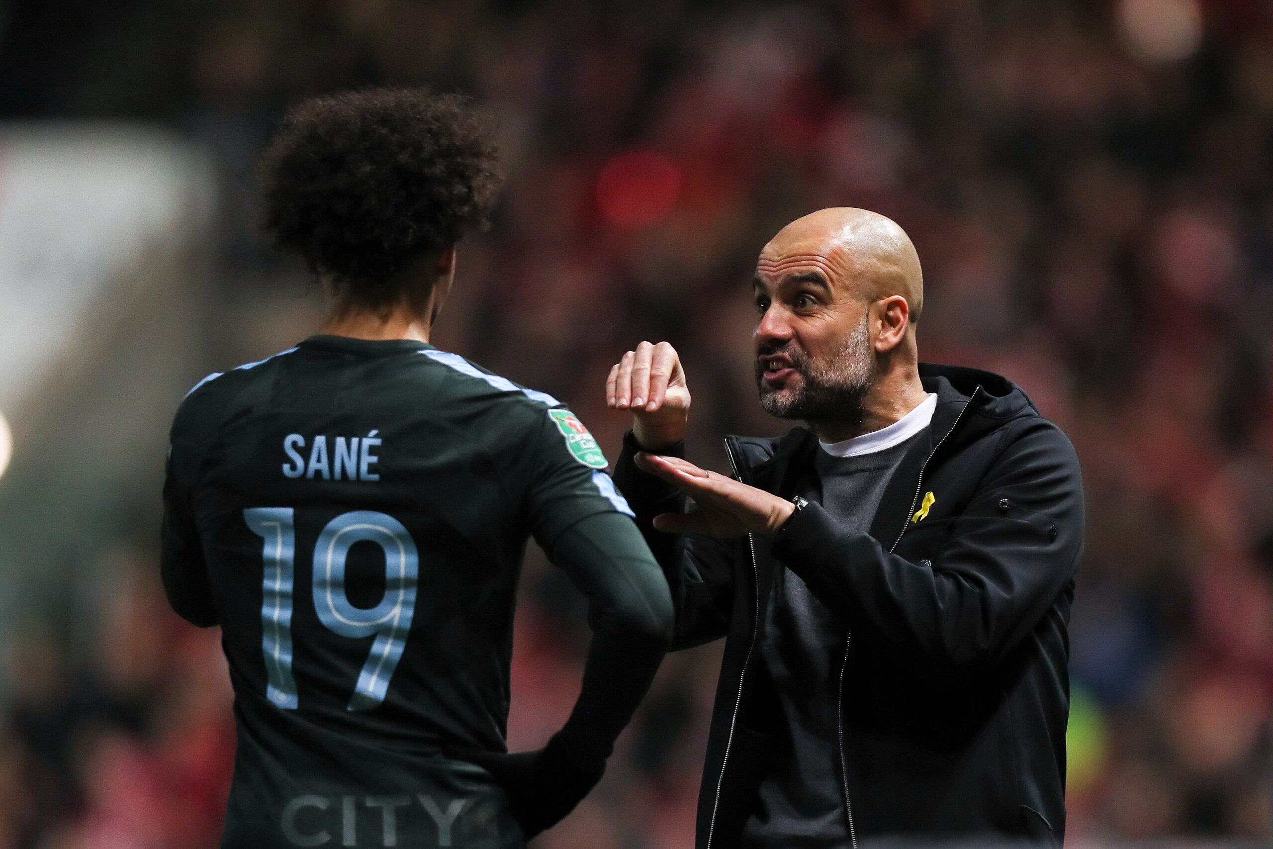 BRISTOL, ENGLAND - JANUARY 23: Leroy Sane of Manchester City and Pep Guardiola the head coach / manager of Manchester City during the Carabao Cup Semi-Final: Second Leg between Bristol City and Manchester City at Ashton Gate on January 23, 2018 in Bristol