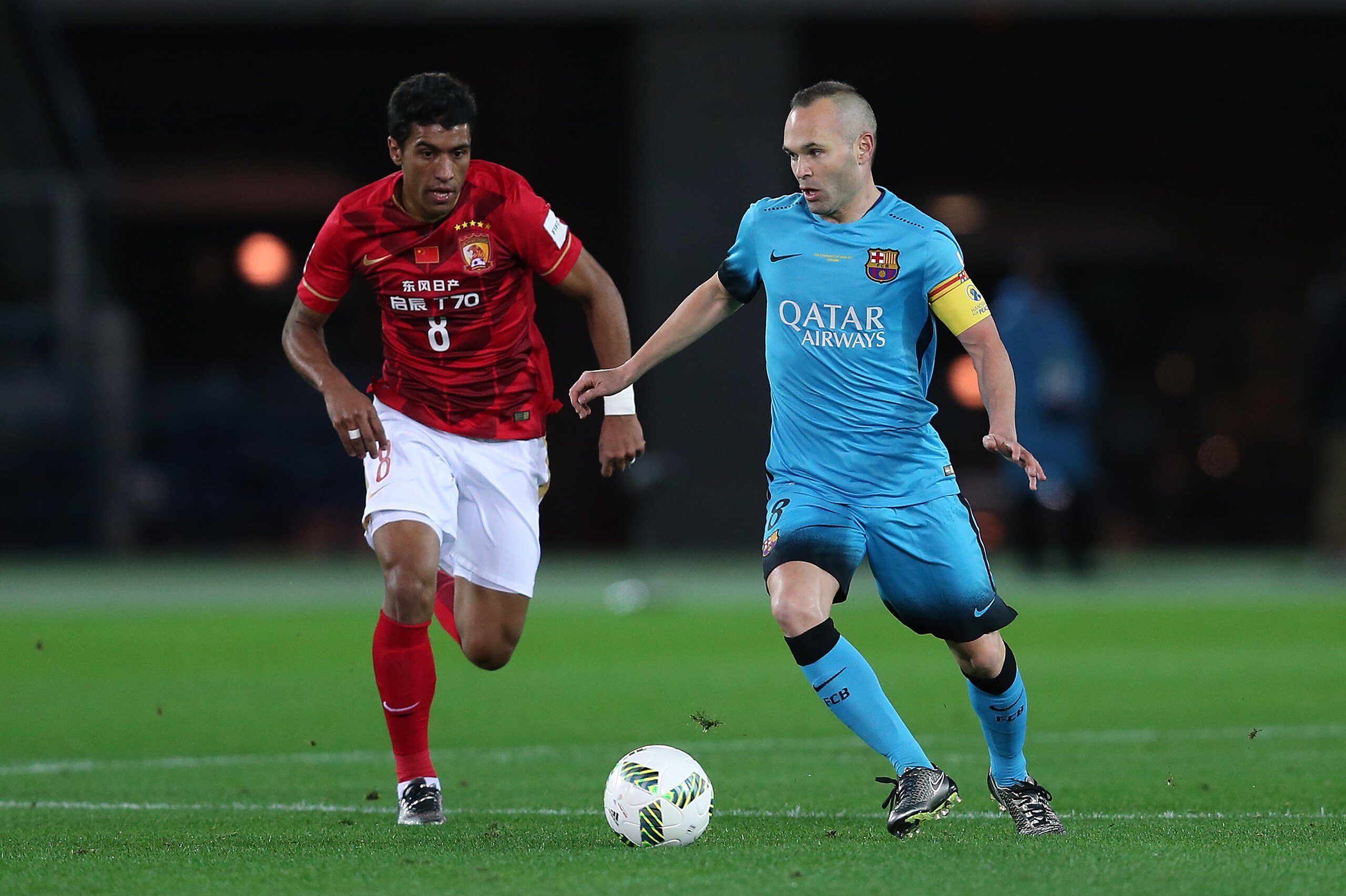 YOKOHAMA, JAPAN - DECEMBER 17: Andres Iniesta of Barcelona in action with Paulinho of Guangzhou Evergrande FC during the FIFA Club World Cup Semi Final match between Barcelona and Guangzhou Evergrande FC at the International Stadium Yokohama on December 1