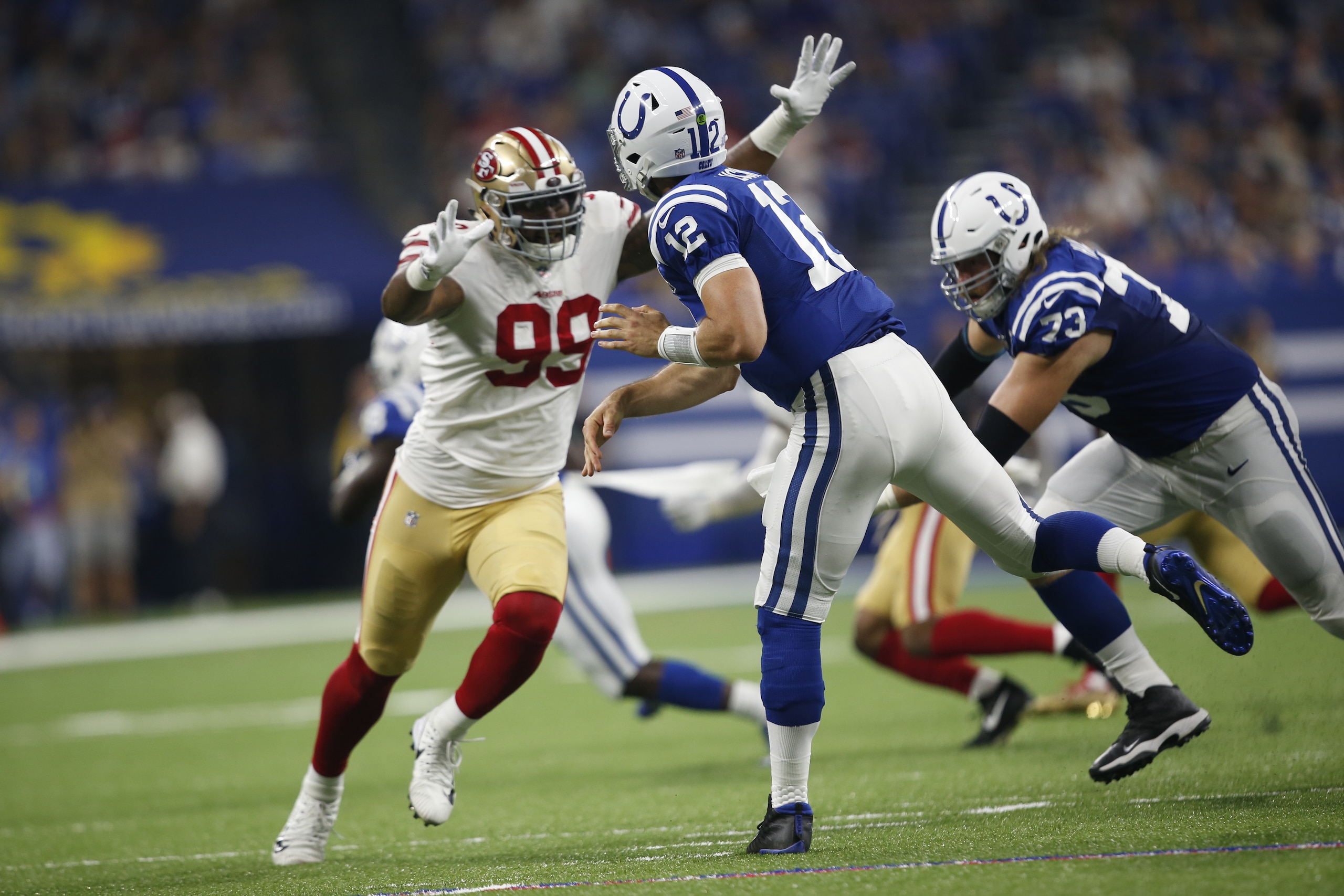 INDIANAPOLIS, IN - AUGUST 25: DeForest Buckner #99 of the San Francisco 49ers pressures Andrew Luck #12 of the Indianapolis Colts during the game at Lucas Oil Stadium on August 25, 2018 in Indianapolis, Indiana. The Colts defeated the 49ers 23-17. (Photo INDIANAPOLIS, IN - AUGUST 25: DeForest Buckner #99 of the San Francisco 49ers pressures Andrew Luck #12 of the Indianapolis Colts during the game at Lucas Oil Stadium on August 25, 2018 in Indianapolis, Indiana. The Colts defeated the 49ers 23-17. (Photo