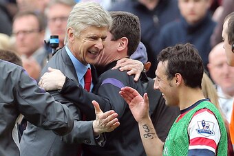 Arsenal's French manager Arsene Wenger (L) celebrates with Arsenal's Spanish midfielder Santi Cazorla (R) at the final whistle of the English Premier League football match between Newcastle United and Arsenal at St James' Park in Newcastle Upon Tyne, nort