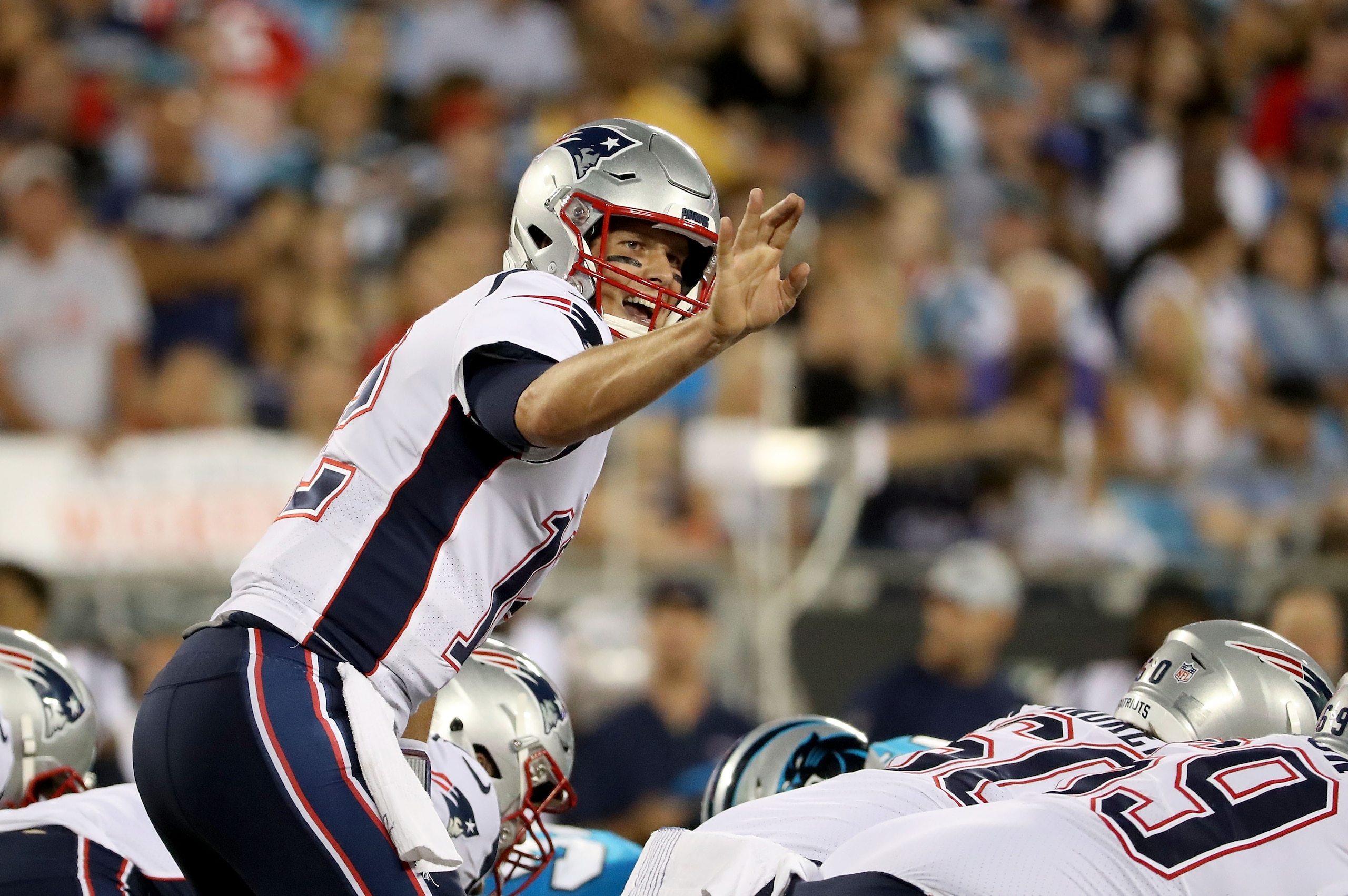 CHARLOTTE, NC - AUGUST 24:  Tom Brady #12 of the New England Patriots makes a call at the line against the Carolina Panthers in the second quarter during their game at Bank of America Stadium on August 24, 2018 in Charlotte, North Carolina.  (Photo by Str