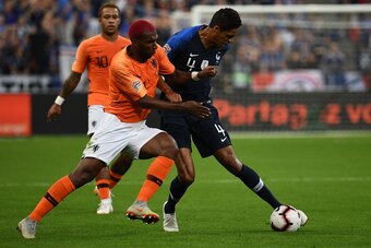 Netherlands' midfielder Ryan Babel (L) vies for the ball with France's defender Raphael Varane during the UEFA Nations League football match between France and Netherlands at the Stade de France stadium, in Saint-Denis, northern of Paris, on September 9, 
