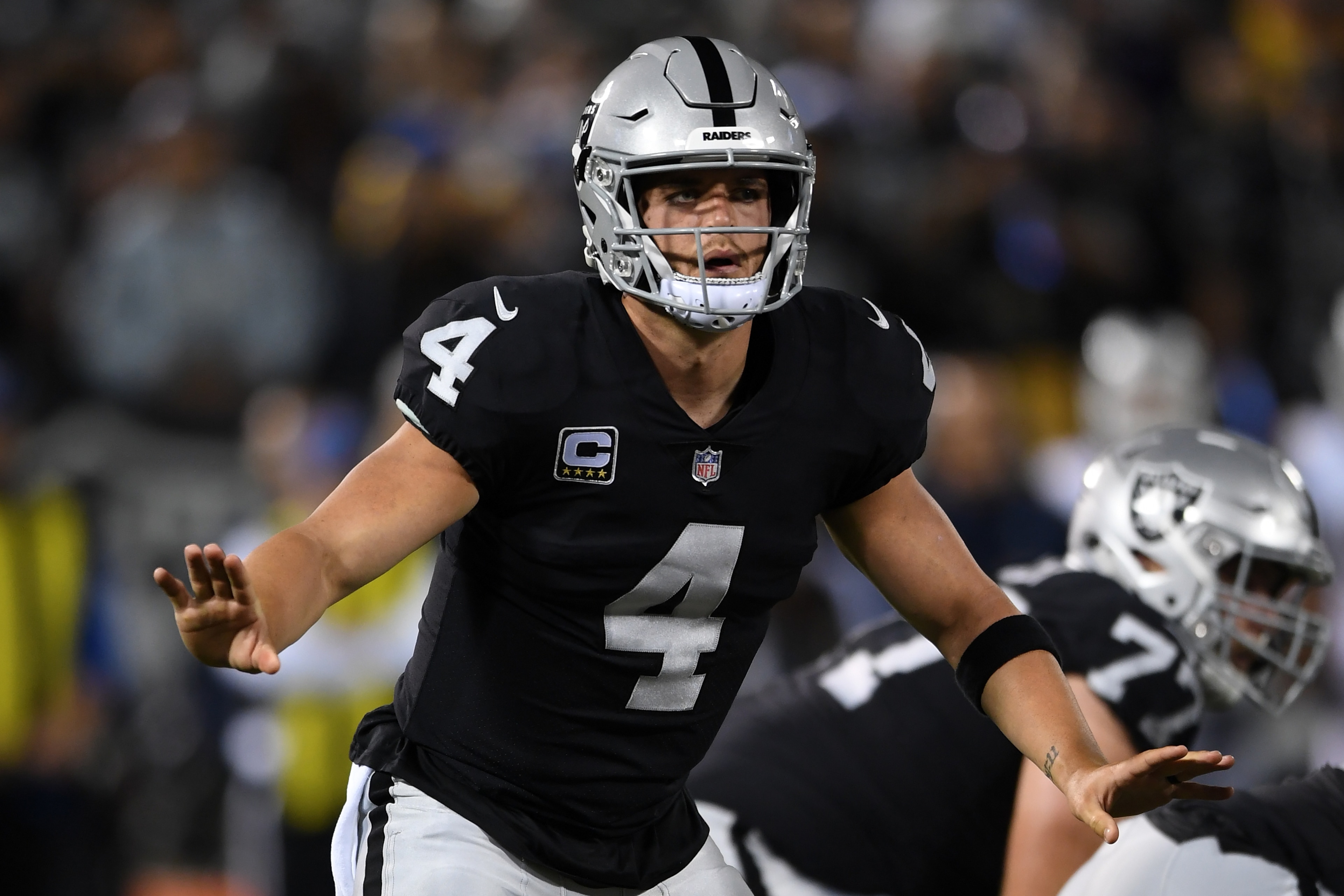 OAKLAND, CA - SEPTEMBER 10:  Derek Carr #4 of the Oakland Raiders signals against the Los Angeles Rams during their NFL game at Oakland-Alameda County Coliseum on September 10, 2018 in Oakland, California.  (Photo by Thearon W. Henderson/Getty Images)