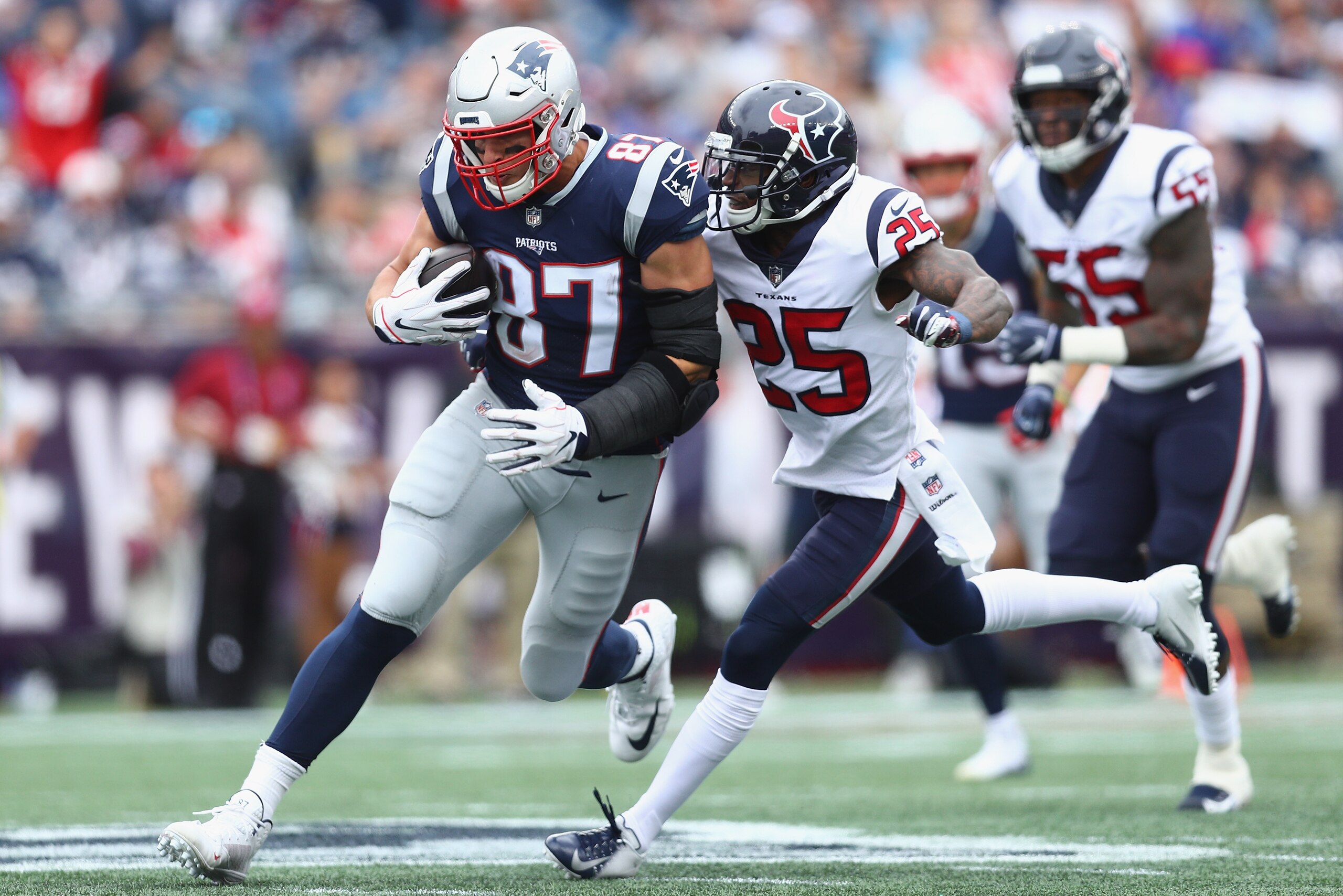 FOXBOROUGH, MA - SEPTEMBER 09:  Kareem Jackson #25 of the Houston Texans tackles Rob Gronkowski #87 of the New England Patriots during the second half at Gillette Stadium on September 9, 2018 in Foxborough, Massachusetts.  (Photo by Maddie Meyer/Getty Ima