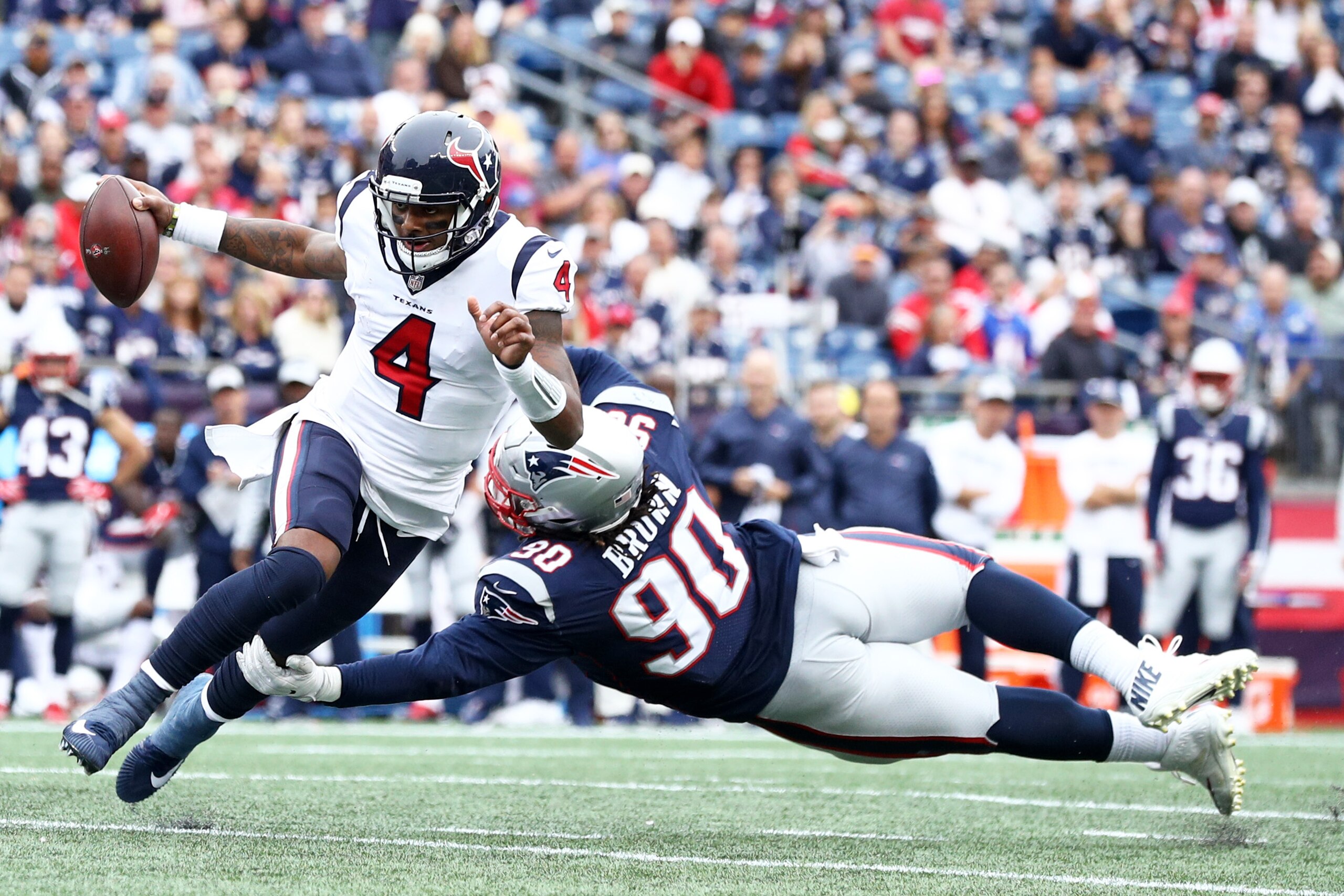 FOXBOROUGH, MA - SEPTEMBER 9: Malcom Brown #90 of the New England Patriots tackles Deshaun Watson #4 of the Houston Texans during their game on September 9, 2018 at Gillette Stadium in Foxborough, Massachusetts.(Photo by Maddie Meyer/Getty Images)