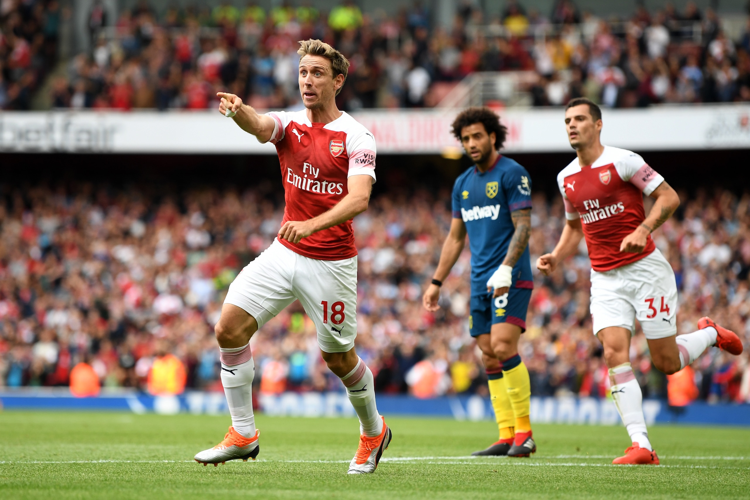 LONDON, ENGLAND - AUGUST 25:  Nacho Monreal of Arsenal celebrates after scoring his team's first goal during the Premier League match between Arsenal FC and West Ham United at Emirates Stadium on August 25, 2018 in London, United Kingdom.  (Photo by Micha