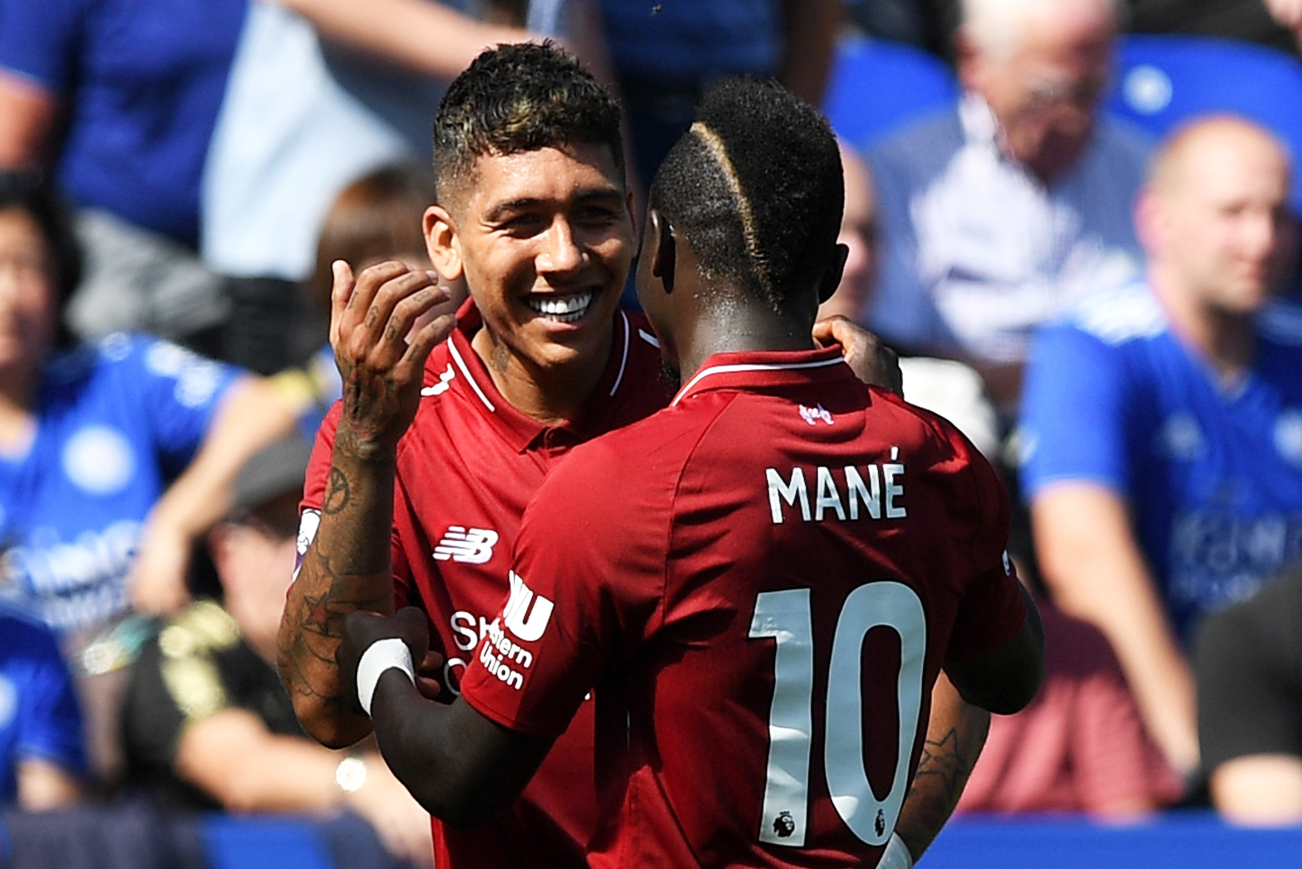 LEICESTER, ENGLAND - SEPTEMBER 01:  Roberto Firmino of Liverpool celebrates after scoring his team's second goal with Sadio Mane during the Premier League match between Leicester City and Liverpool FC at The King Power Stadium on September 1, 2018 in Leic