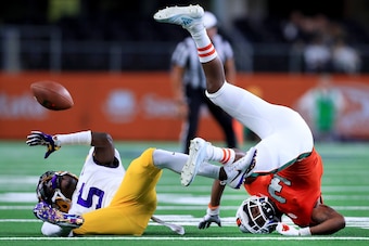 ARLINGTON, TX - SEPTEMBER 02:  Kary Vincent Jr. #5 of the LSU Tigers breaks up a pass intended for Mike Harley #3 of the Miami Hurricanes in the fourth quarter of The AdvoCare Classic at AT&T Stadium on September 2, 2018 in Arlington, Texas.  (Photo by To