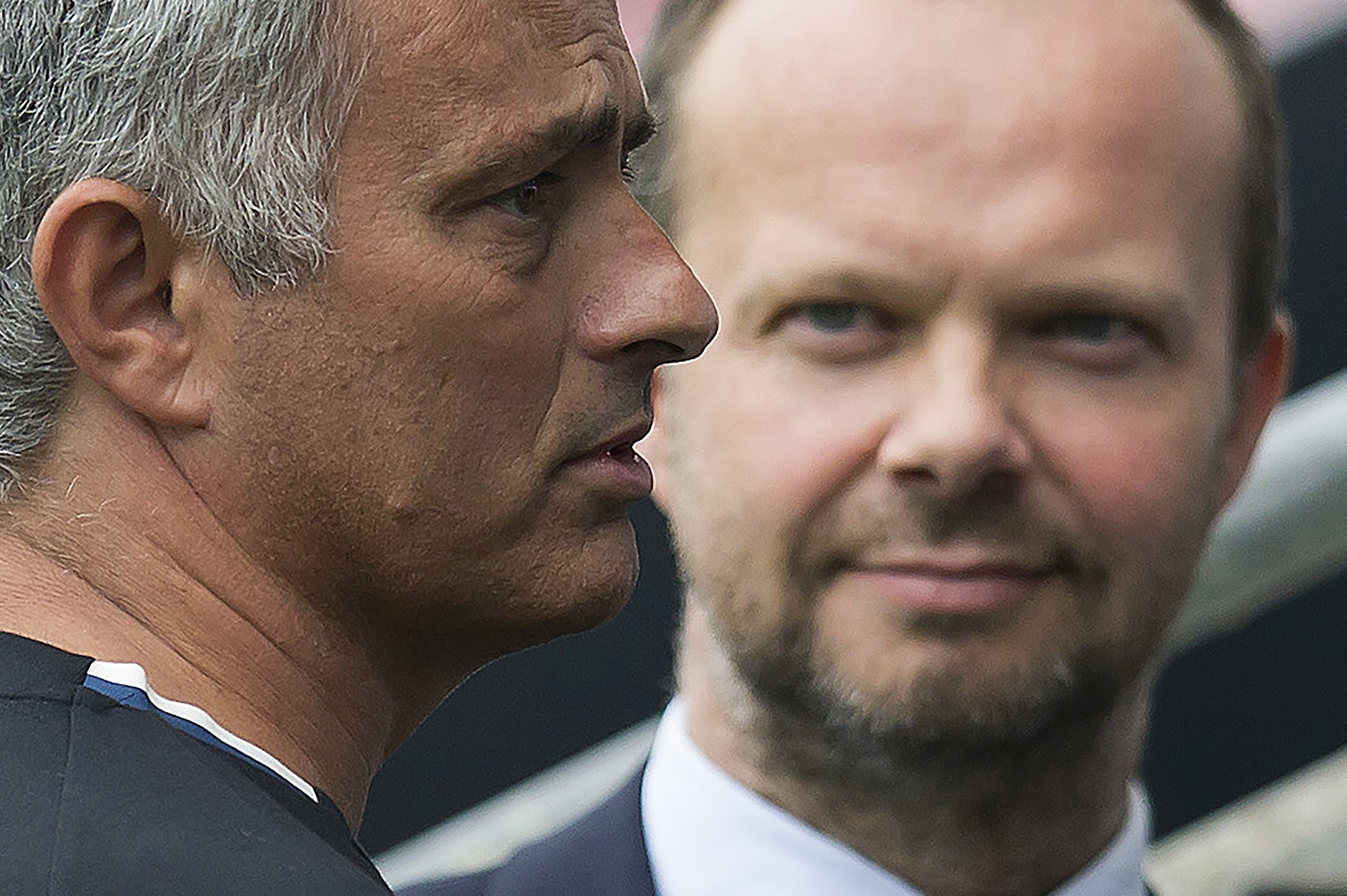 Manchester United's executive vice-chairman Ed Woodward (R) listens as Manchester United's Portuguese manager Jose Mourinho talks with former Manchester United player Bobby Charlton (not pictured) following the pre-season friendly football match between W