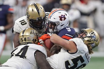 ATLANTA, GA - JANUARY 01:  Kam Martin #9 of the Auburn Tigers is tackled by the UCF Knights in the second half during the Chick-fil-A Peach Bowl at Mercedes-Benz Stadium on January 1, 2018 in Atlanta, Georgia.  (Photo by Streeter Lecka/Getty Images)