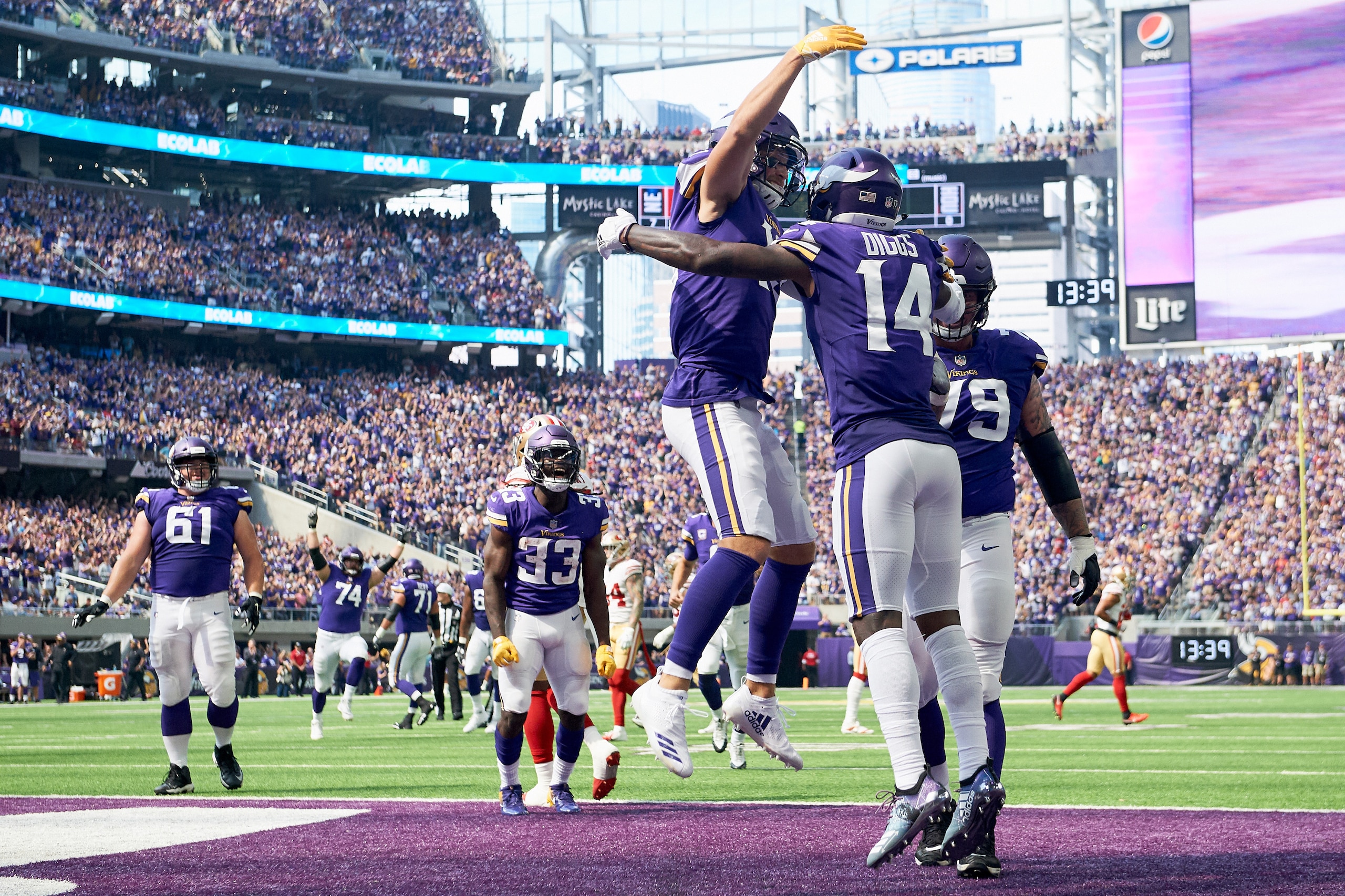 MINNEAPOLIS, MN - SEPTEMBER 09: Adam Thielen #19 of the Minnesota Vikings congratulates teammate Stefon Diggs #14 on a touchdown against the San Francisco 49ers during the game on September 9, 2018 at U.S. Bank Stadium in Minneapolis, Minnesota. The Vikin