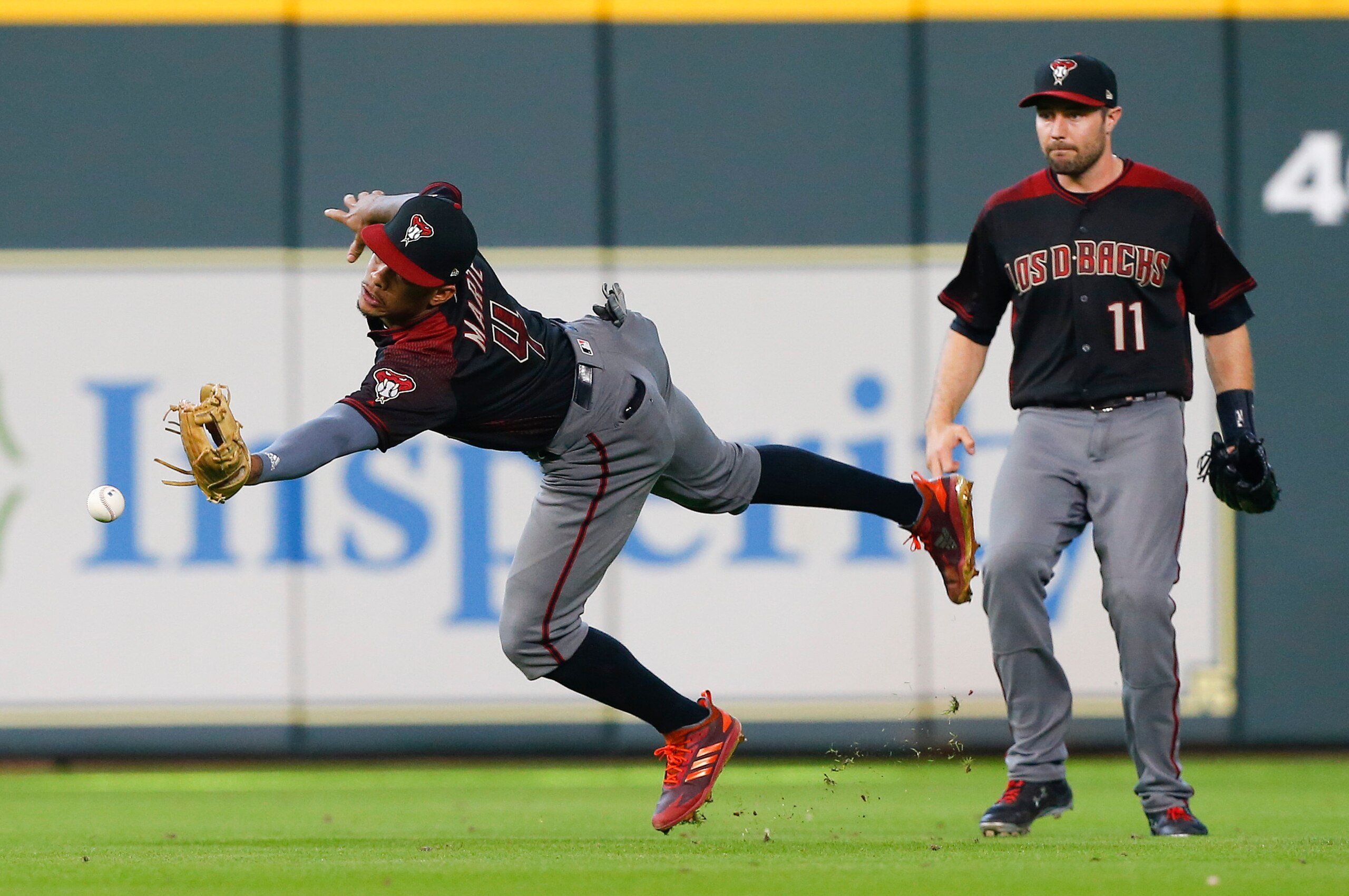 HOUSTON, TX - SEPTEMBER 16:  Ketel Marte #4 of the Arizona Diamondbacks can't make the catch on a pop fly by Carlos Correa #1 of the Houston Astros in the eighth inning at Minute Maid Park on September 16, 2018 in Houston, Texas.  (Photo by Bob Levey/Gett