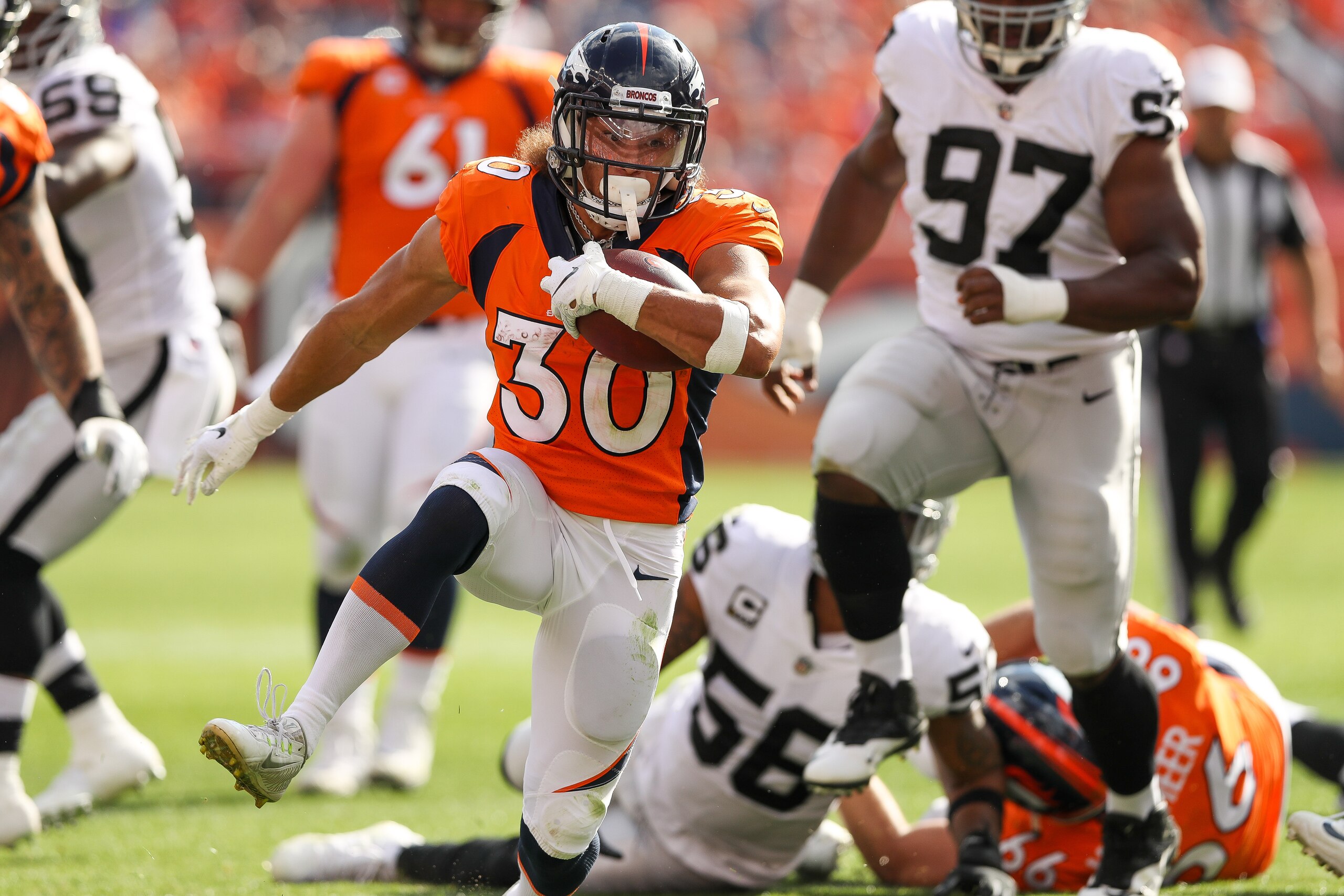 DENVER, CO - SEPTEMBER 16:  Running back Phillip Lindsay #30 of the Denver Broncos rushes against the Oakland Raiders at Broncos Stadium at Mile High on September 16, 2018 in Denver, Colorado. (Photo by Matthew Stockman/Getty Images)