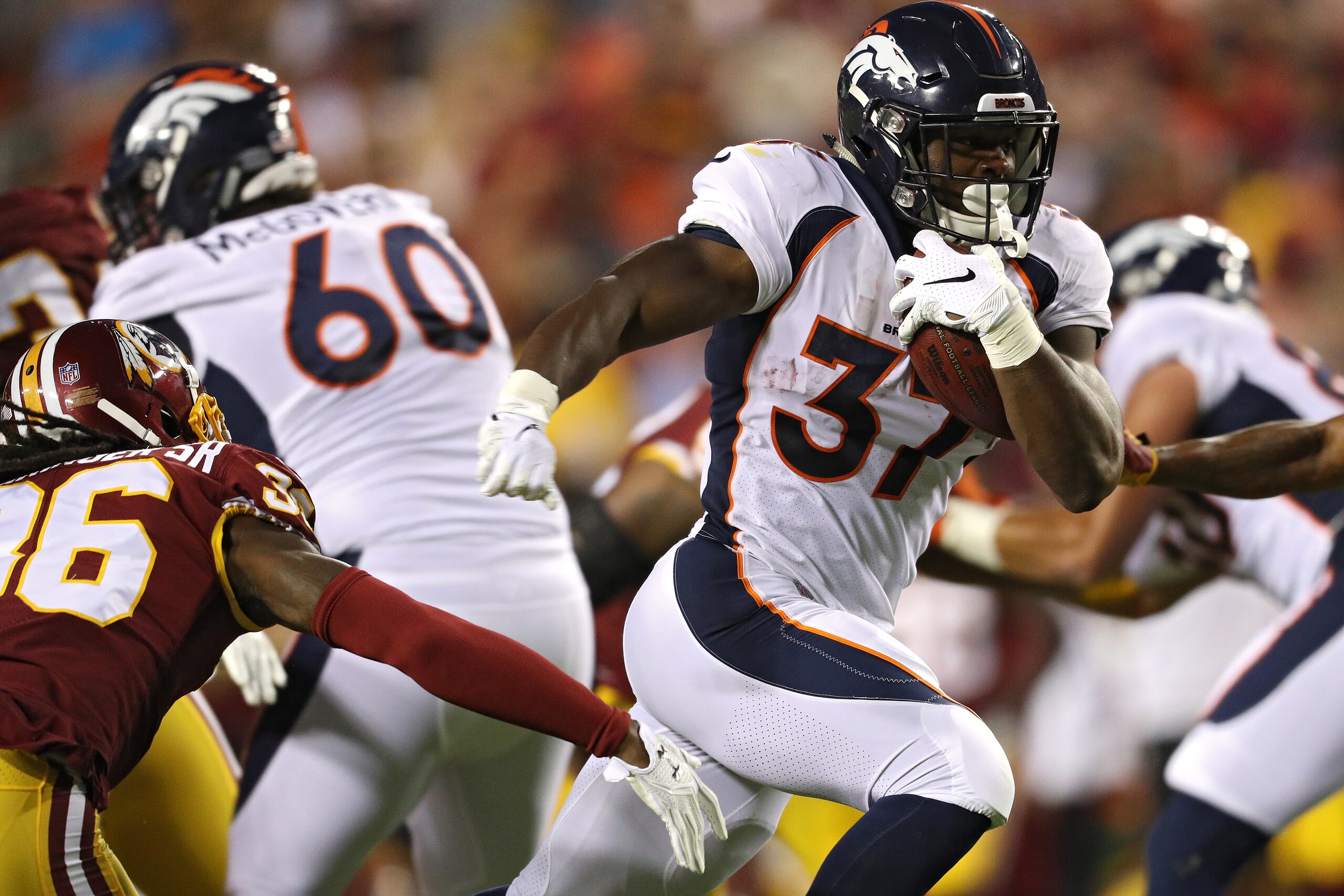 LANDOVER, MD - AUGUST 24: Running back Royce Freeman #37 of the Denver Broncos rushes for a touchdown against the Washington Redskins in the first quarter during a preseason game at FedExField on August 24, 2018 in Landover, Maryland. (Photo by Patrick Sm