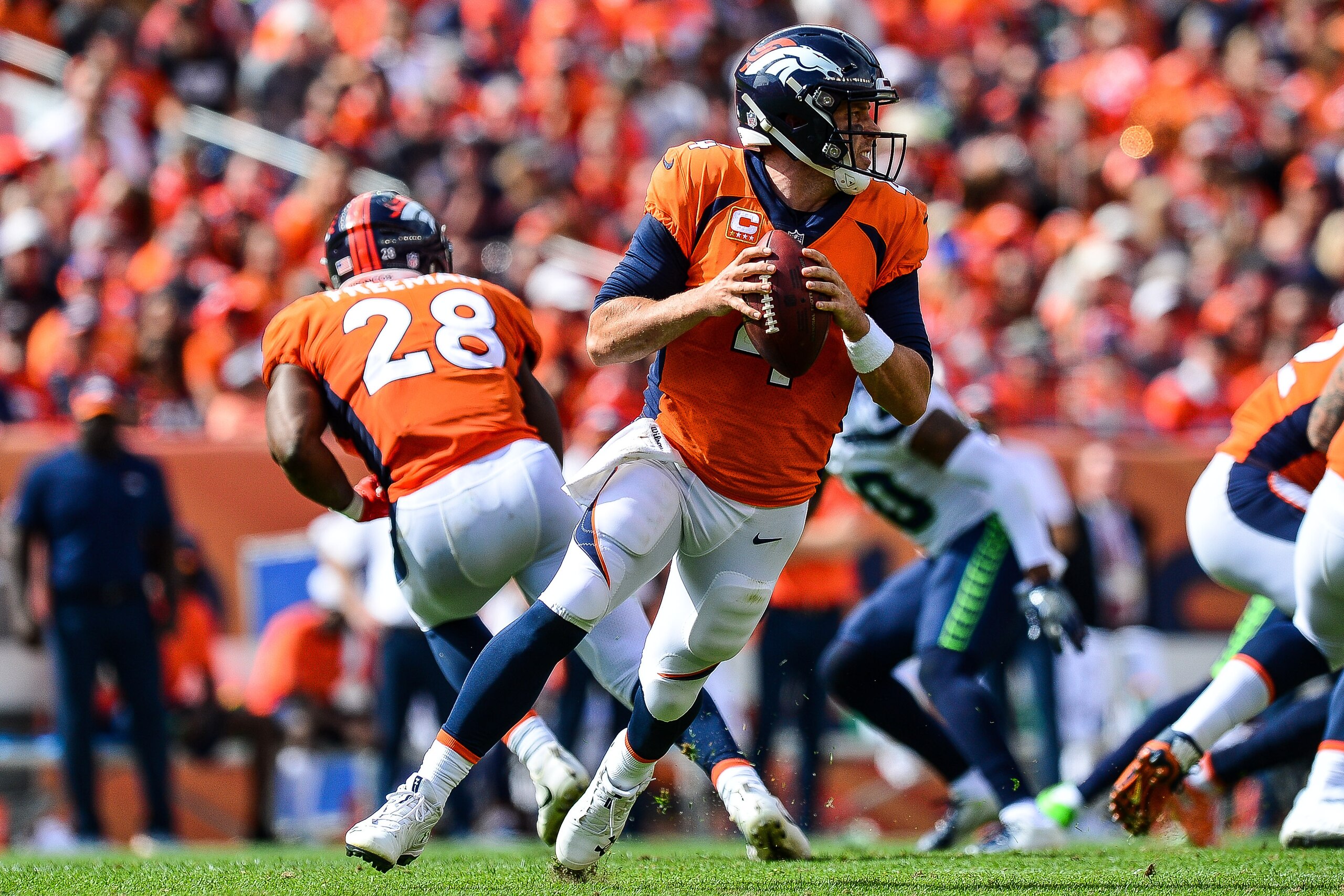 DENVER, CO - SEPTEMBER 9:  Quarterback Case Keenum #4 of the Denver Broncos rolls out of the pocket against the Seattle Seahawks at Broncos Stadium at Mile High on September 9, 2018 in Denver, Colorado. (Photo by Dustin Bradford/Getty Images)