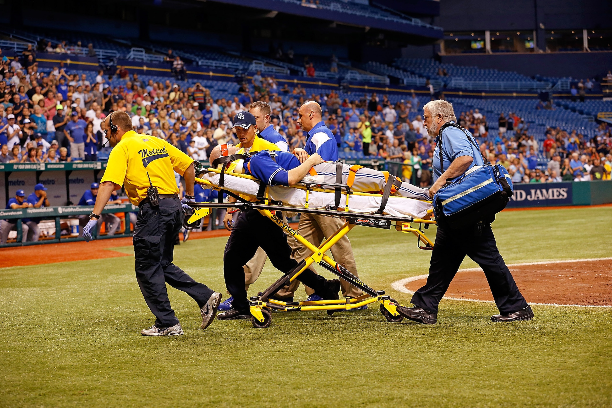 ST. PETERSBURG - MAY 07:  Pitcher J.A. Happ #48 of the Toronto Blue Jays is taken off the field after he was hit by a line drive from the Tampa Bay Rays during the game at Tropicana Field on May 7, 2013 in St. Petersburg, Florida.  (Photo by J. Meric/Gett