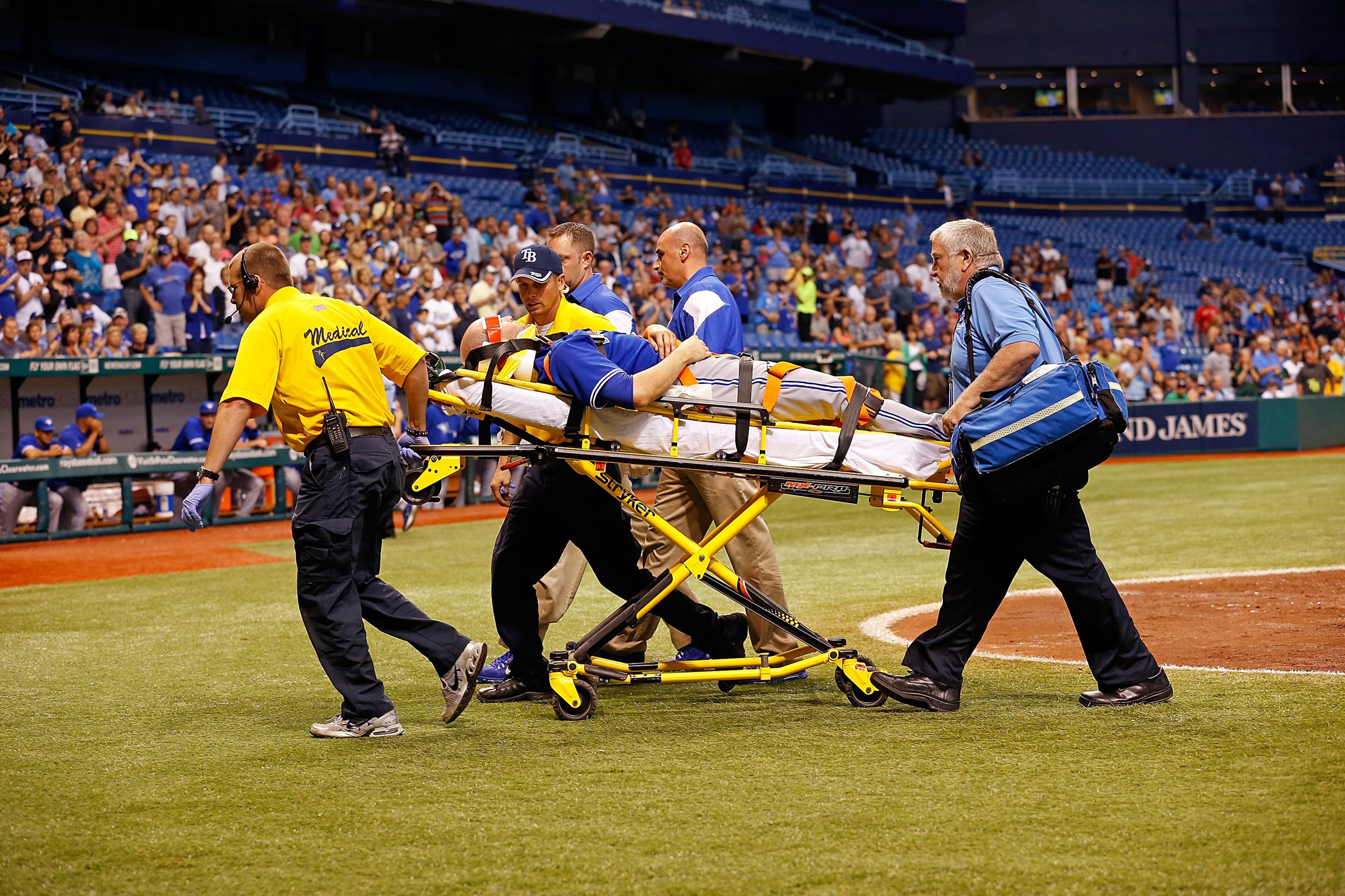 ST. PETERSBURG - MAY 07:  Pitcher J.A. Happ #48 of the Toronto Blue Jays is taken off the field after he was hit by a line drive from the Tampa Bay Rays during the game at Tropicana Field on May 7, 2013 in St. Petersburg, Florida.  (Photo by J. Meric/Gett