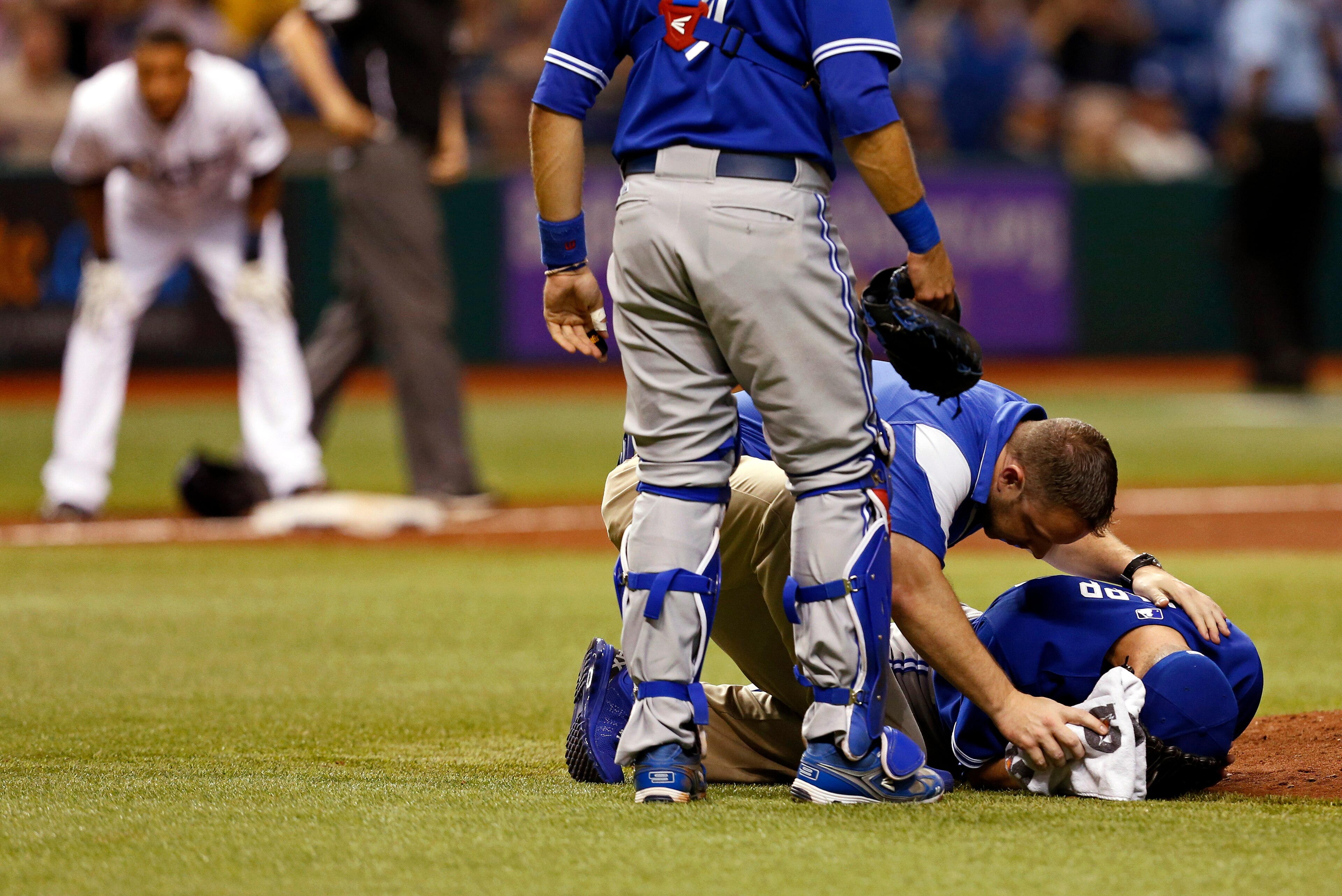 J.A. Happ was bleeding from his right ear when Blue Jays assistant athletic trainer Mike Frostad reached him at the mound. Meanwhile, Desmond Jennings, who hit the ball that hit Happ, stood at third base, watching uncomfortably.