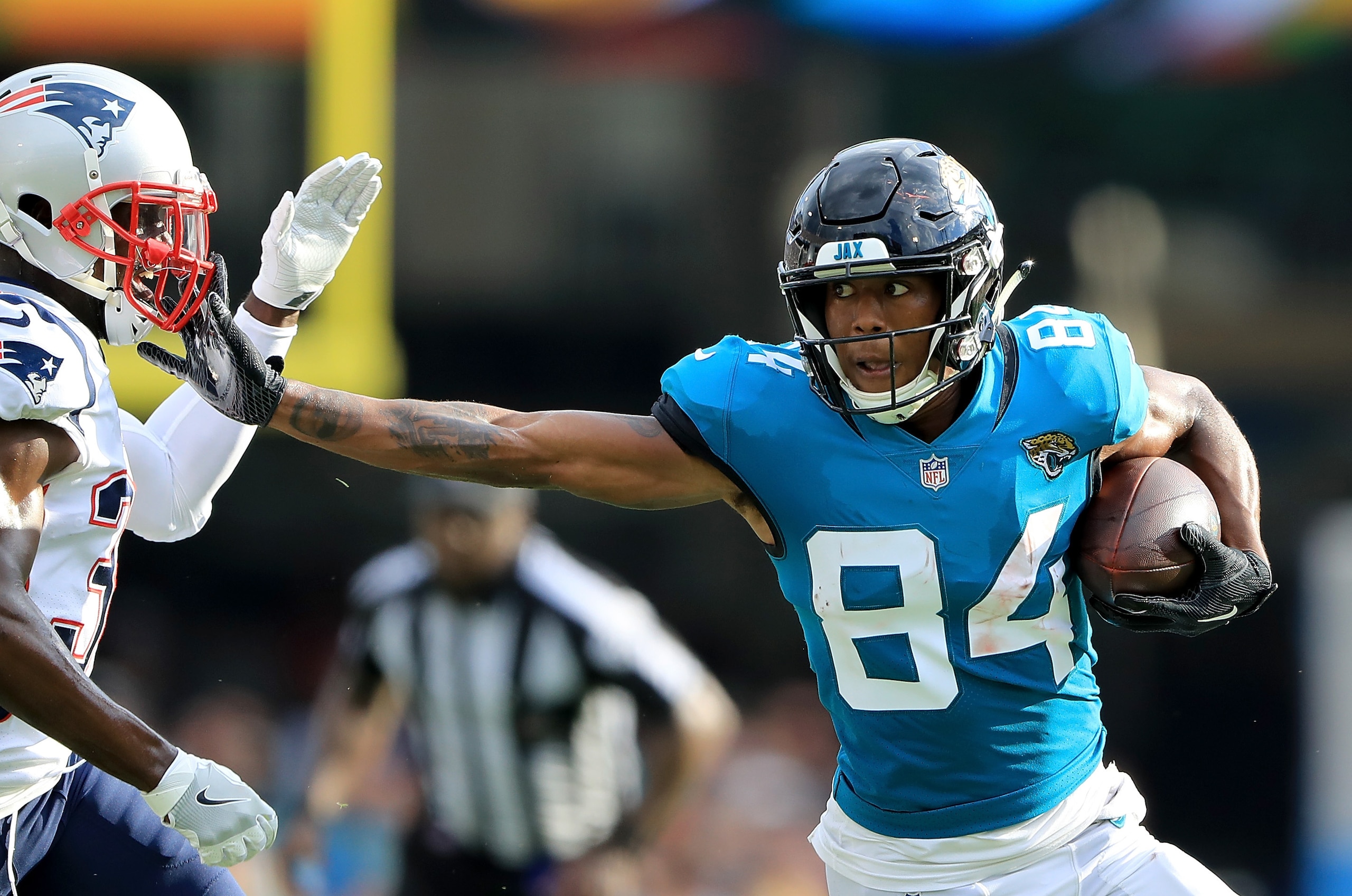JACKSONVILLE, FL - SEPTEMBER 16:  Keelan Cole #84 of the Jacksonville Jaguars attempts to run past Jason McCourty #30 of the New England Patriots during the game at TIAA Bank Field on September 16, 2018 in Jacksonville, Florida.  (Photo by Sam Greenwood/G