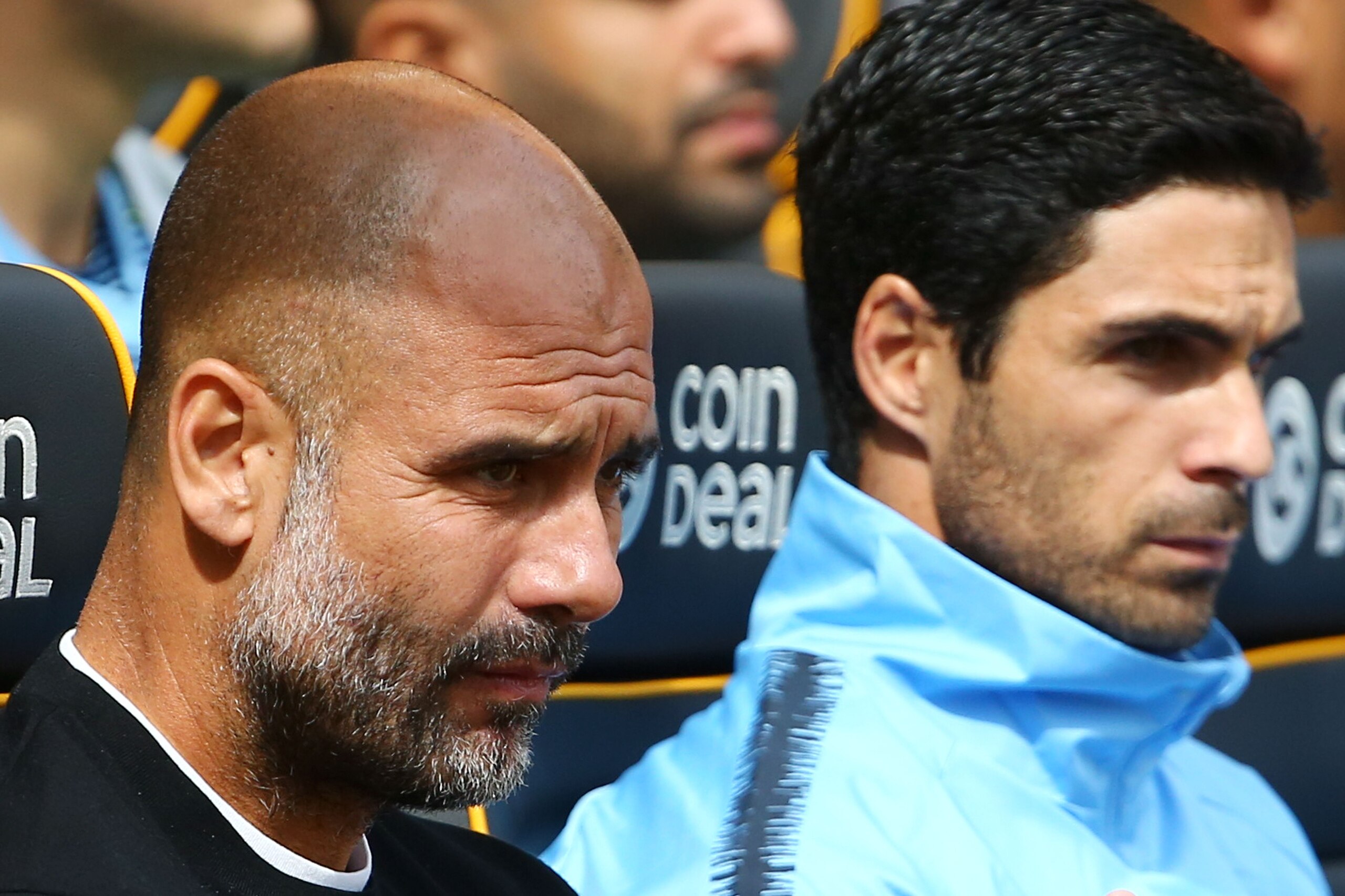 Manchester City's Spanish manager Pep Guardiola (L) and assistant coach Mikel Arteta (R) are seen in the dug out before kick off of the English Premier League football match between Wolverhampton Wanderers and Manchester City at the Molineux stadium in Wo