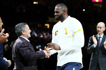 CLEVELAND, OH - OCTOBER 25: LeBron James #23 of the Cleveland Cavaliers recieves his championship ring from owner Dan Gilbert before the game against the New York Knicks at Quicken Loans Arena on October 25, 2016 in Cleveland, Ohio.   NOTE TO USER: User e