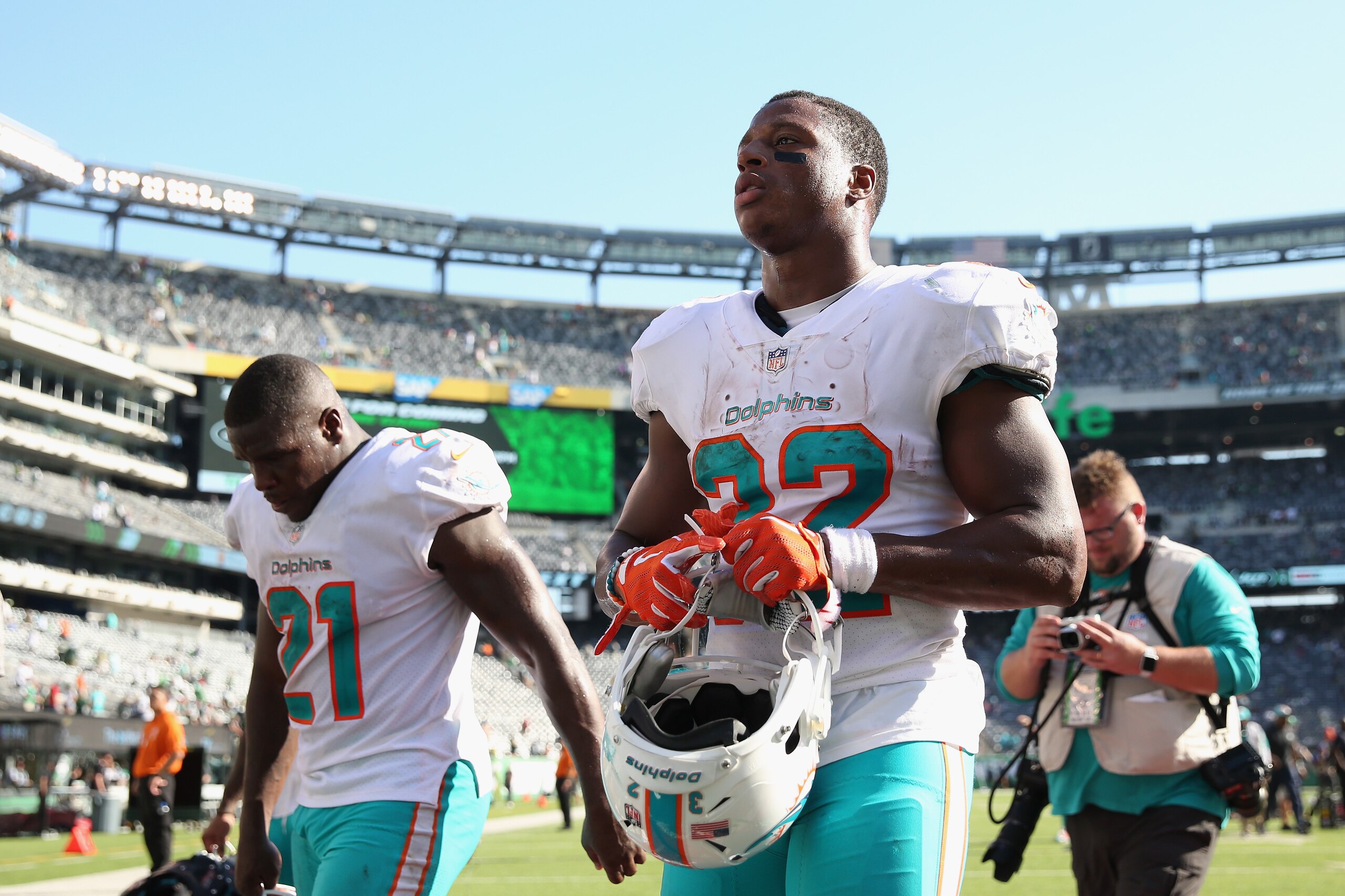 EAST RUTHERFORD, NJ - SEPTEMBER 16:  Running back Frank Gore #21 and running back Kenyan Drake #32 of the Miami Dolphins walk off field after their 20-12 win over the New York Jets at MetLife Stadium on September 16, 2018 in East Rutherford, New Jersey.  