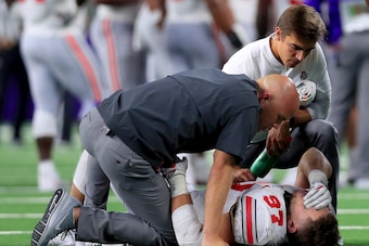 ARLINGTON, TX - SEPTEMBER 15:  Nick Bosa #97 of the Ohio State Buckeyes lays on the field after being injured in the third quarter against the TCU Horned Frogs during The AdvoCare Showdown at AT&T Stadium on September 15, 2018 in Arlington, Texas.  (Photo