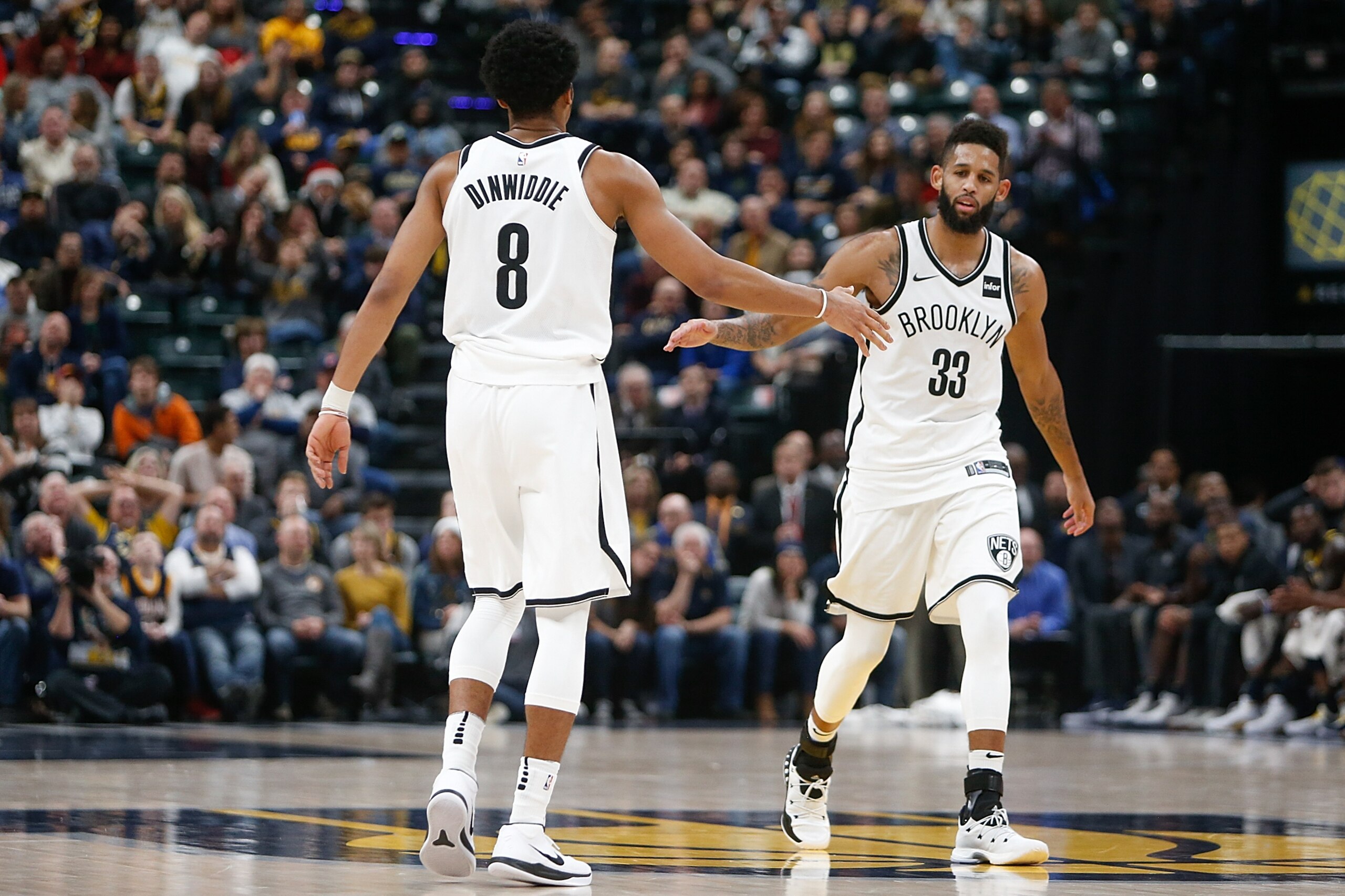 INDIANAPOLIS, IN - DECEMBER 23:  Allen Crabbe #33 of the Brooklyn Nets celebrates with Spencer Dinwiddie #8 against the Indiana Pacers during the second half at Bankers Life Fieldhouse on December 23, 2017 in Indianapolis, Indiana. NOTE TO USER: User expr