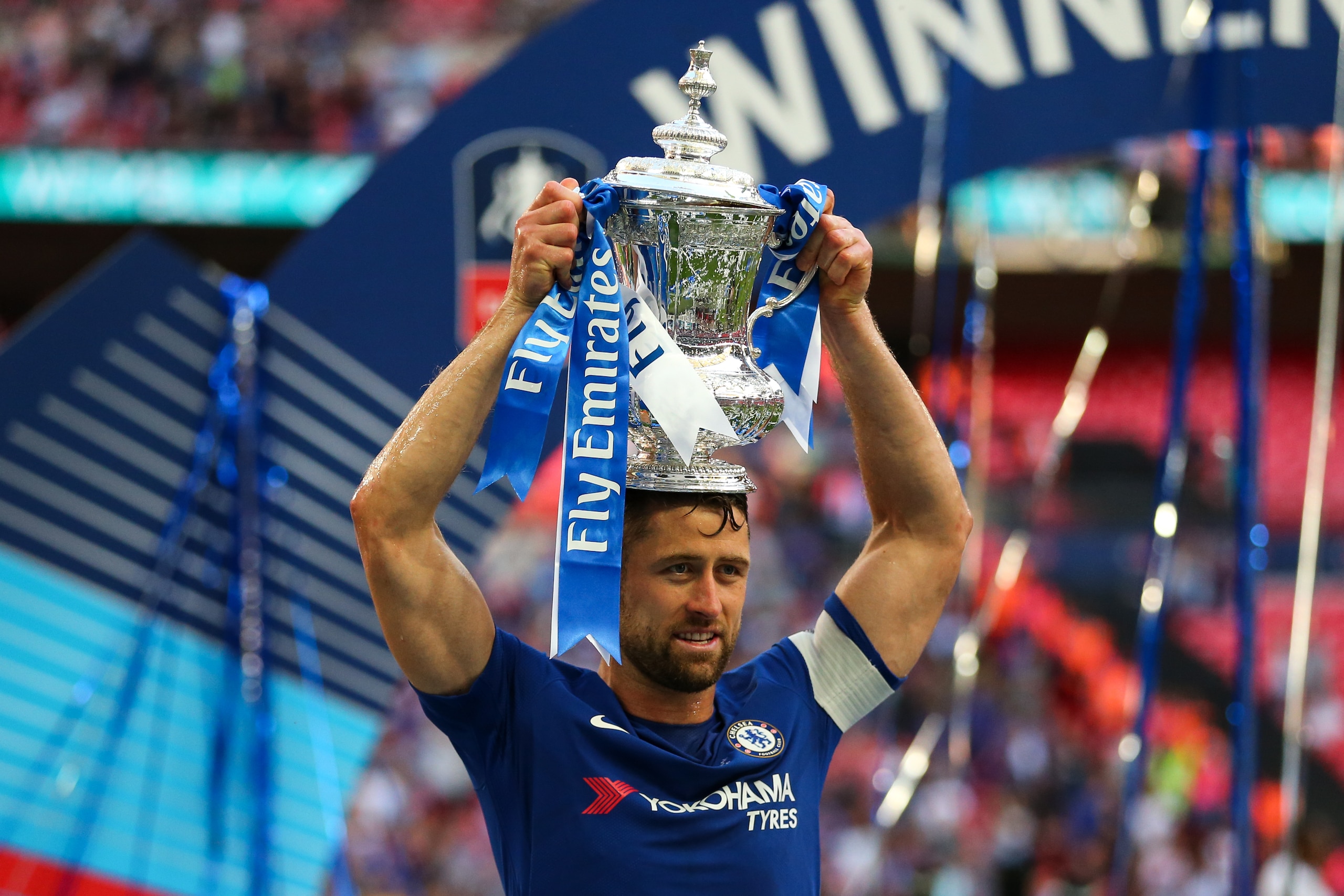 LONDON, ENGLAND - MAY 19: Gary Cahill of Chelsea celebrates with the FA Cup trophy during The Emirates FA Cup Final between Chelsea and Manchester United at Wembley Stadium on May 19, 2018 in London, England. (Photo by Robbie Jay Barratt - AMA/Getty Image