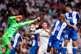 Espanyol's Spanish goalkeeper Diego Lopez (L) jumps for the ball next to Real Madrid's Spanish defender Sergio Ramos (C) and Espanyol's Brazilian defender Naldo and Espanyol's Spanish midfielder Marc Roca during the Spanish league football match between R