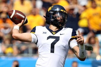 CHARLOTTE, NC - SEPTEMBER 01:  Will Grier #7 of the West Virginia Mountaineers drops back to pass against the Tennessee Volunteers during their game at Bank of America Stadium on September 1, 2018 in Charlotte, North Carolina.  (Photo by Streeter Lecka/Ge