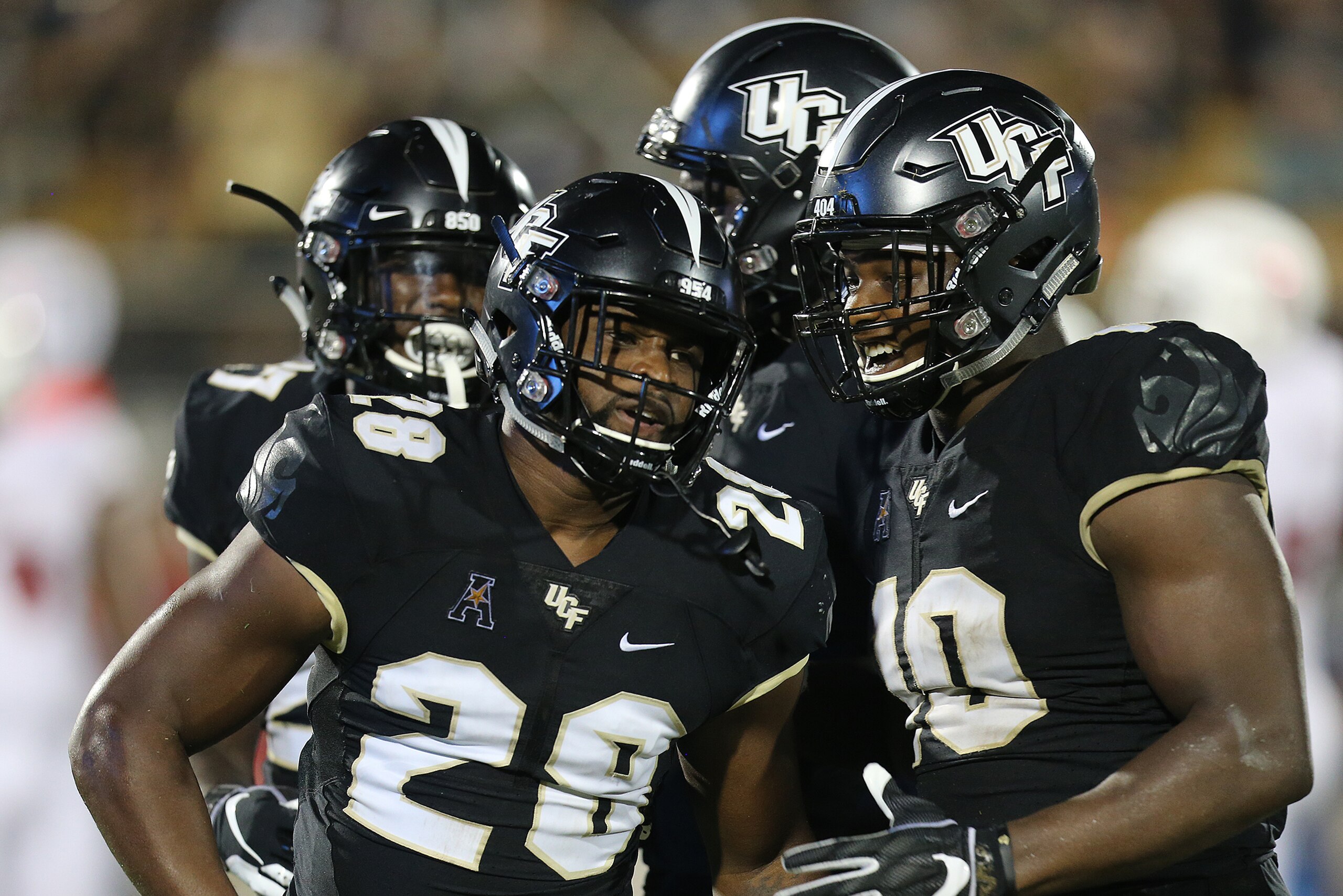 ORLANDO, FL - SEPTEMBER 21:  Shawn Burgess-Becker #28 of the UCF Knights celebrates with Titus Davis #10 of the UCF Knights during a game against the Florida Atlantic Owls at Spectrum Stadium on September 21, 2018 in Orlando, Florida. (Photo by Alex Menen