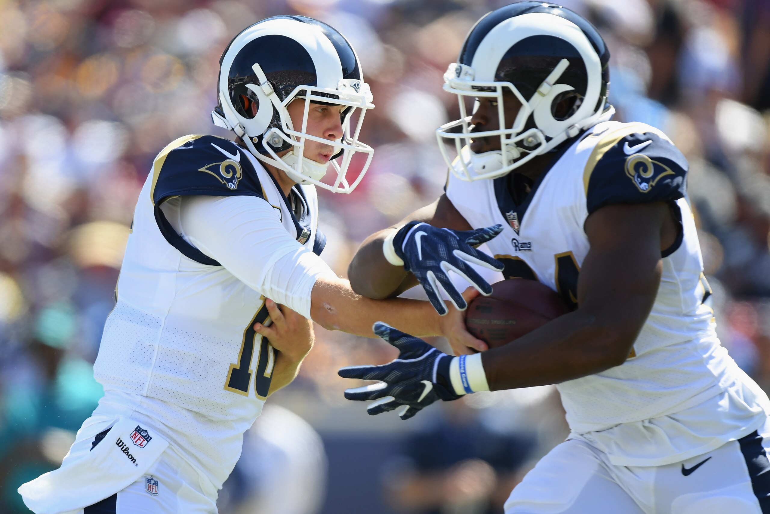 LOS ANGELES, CA - SEPTEMBER 23:  Quarterback Jared Goff #16 of the Los Angeles Rams hands off to Todd Gurley #30 during the second quarter of the game against the Los Angeles Chargers at Los Angeles Memorial Coliseum on September 23, 2018 in Los Angeles, 