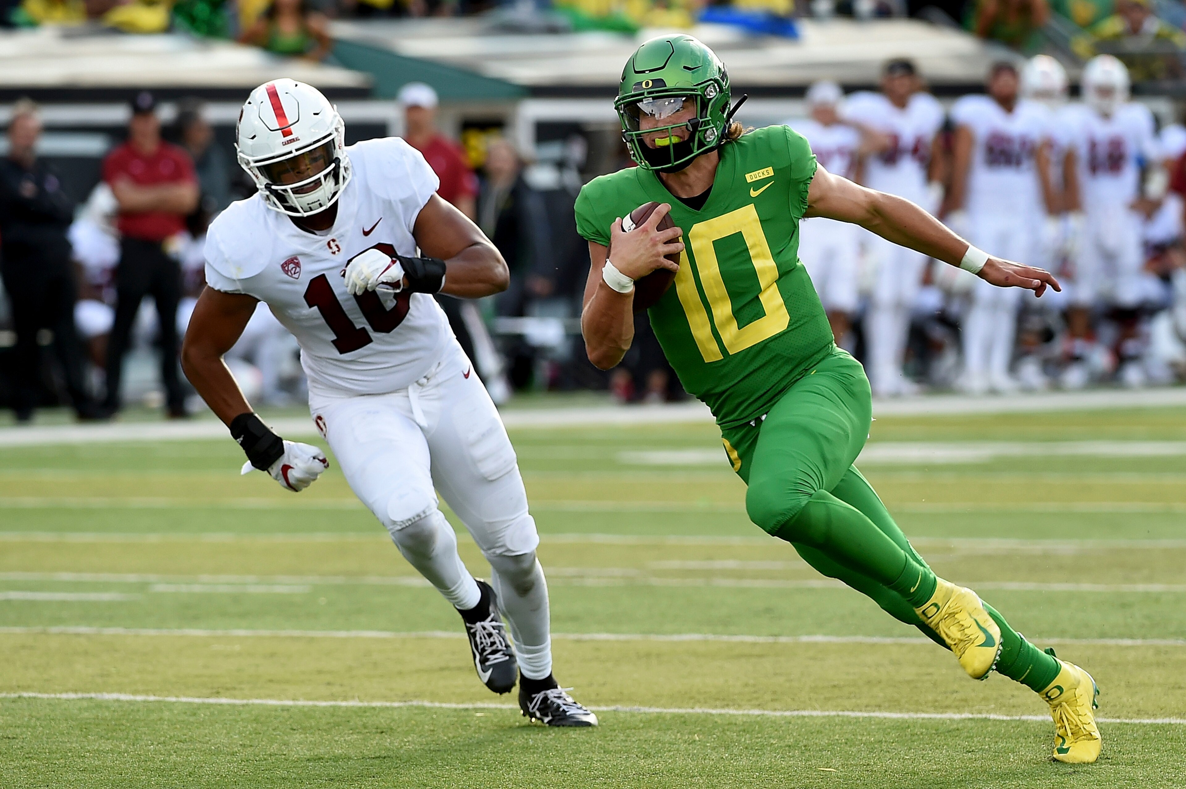 EUGENE, OR - SEPTEMBER 22: Quarterback Justin Herbert #10 of the Oregon Ducks runs with the ball as linebacker Jordan Fox (10) of the Stanford Cardinal gives chase during the first quarter of the game against the Stanford Cardinal at Autzen Stadium on Sep EUGENE, OR - SEPTEMBER 22: Quarterback Justin Herbert #10 of the Oregon Ducks runs with the ball as linebacker Jordan Fox (10) of the Stanford Cardinal gives chase during the first quarter of the game against the Stanford Cardinal at Autzen Stadium on Sep