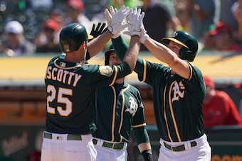 OAKLAND, CA - SEPTEMBER 20:  Stephen Piscotty #25 of the Oakland Athletics is congratulated by Jed Lowrie #8 and Matt Chapman #26 after Piscotty hit a three-run home run against the Los Angeles Angels of Anaheim in the bottom of the third inning at Oaklan