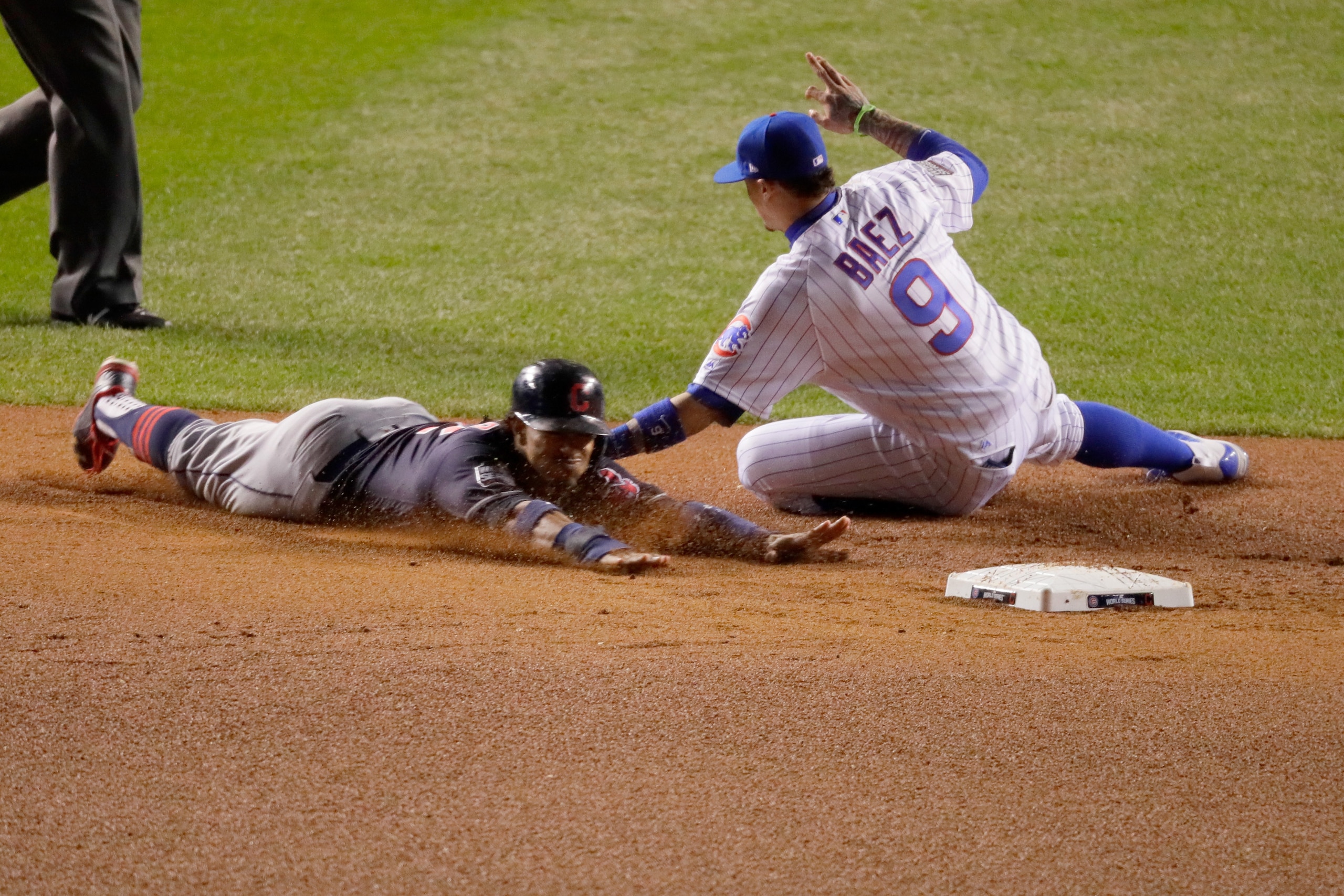 CHICAGO, IL - OCTOBER 30:  Javier Baez #9 of the Chicago Cubs tags out Francisco Lindor #12 of the Cleveland Indians during a stolen base attempt in the sixth inning in Game Five of the 2016 World Series at Wrigley Field on October 30, 2016 in Chicago, Il