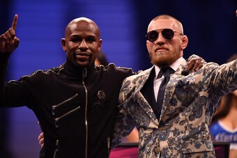 LAS VEGAS, NV - AUGUST 25:  (L-R) Floyd Mayweather Jr. and Conor McGregor pose for pictures during a news conference after Mayweather's 10th-round TKO victory in their super welterweight boxing match on August 26, 2017 at T-Mobile Arena in Las Vegas, Neva