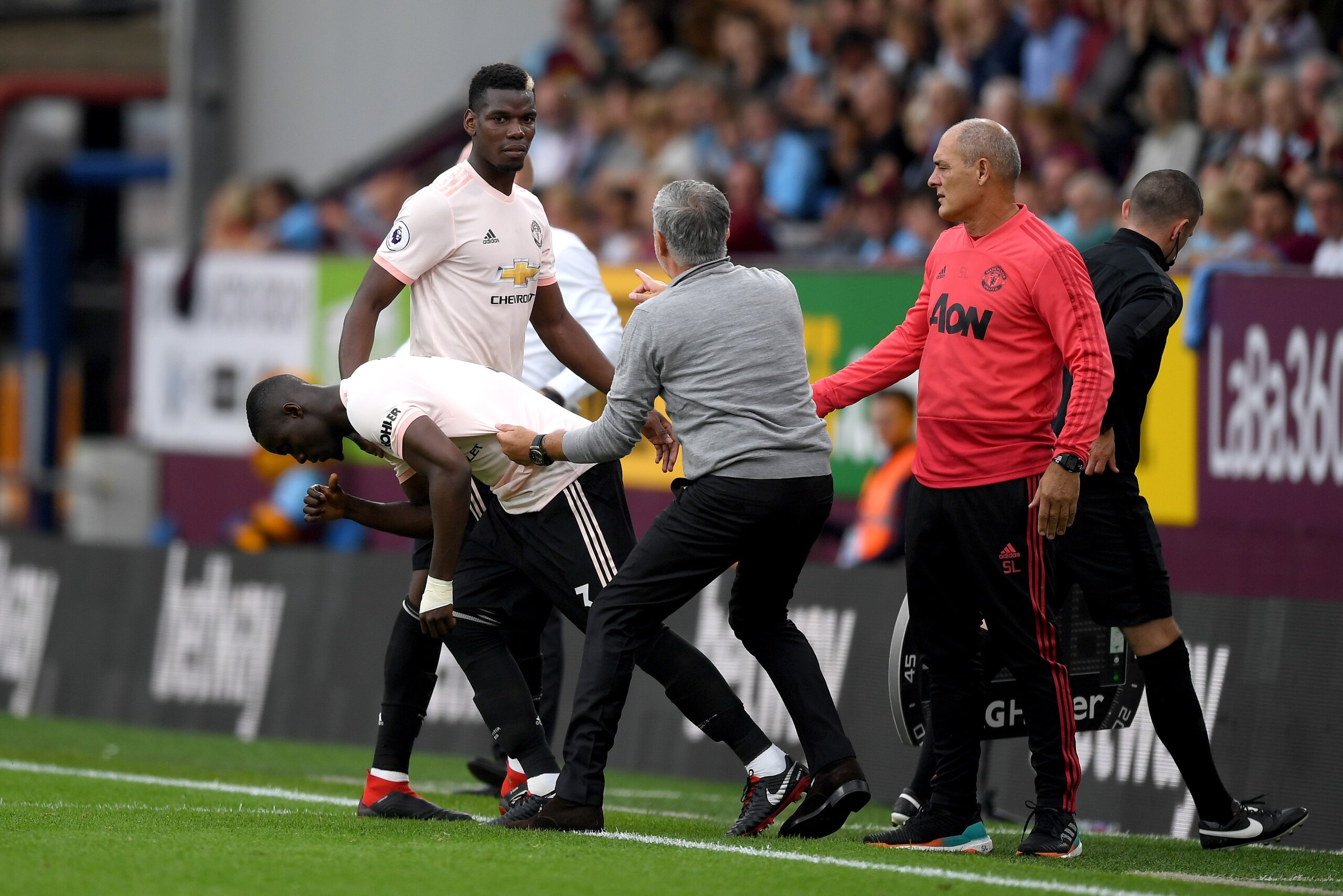 BURNLEY, ENGLAND - SEPTEMBER 02:  Jose Mourinho, Manager of Manchester United holds Eric Bailly of Manchester United as he replaces Paul Pogba of Manchester United during the Premier League match between Burnley FC and Manchester United at Turf Moor on Se