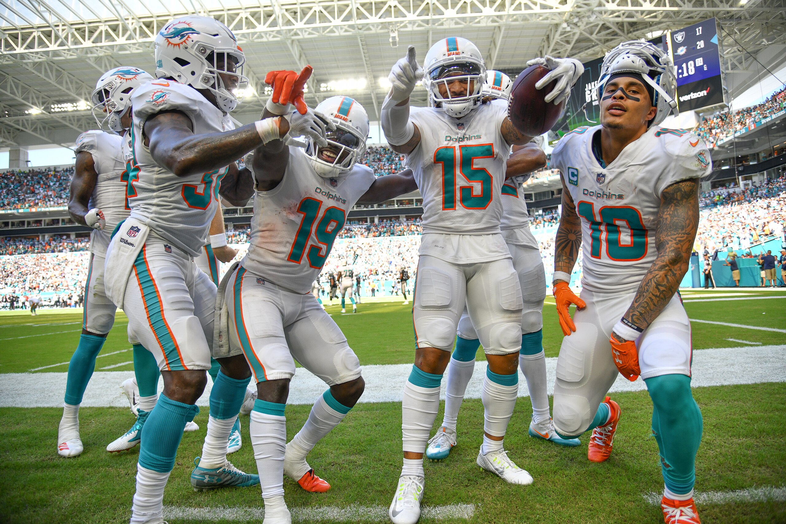 MIAMI, FL - SEPTEMBER 23: Senorise Perry #34, Jakeem Grant #19, Albert Wilson #15 and Kenny Stills #10 of the Miami Dolphins celebrate a touchdown against the Oakland Raiders at Hard Rock Stadium on September 23, 2018 in Miami, Florida. (Photo by Mark Bro