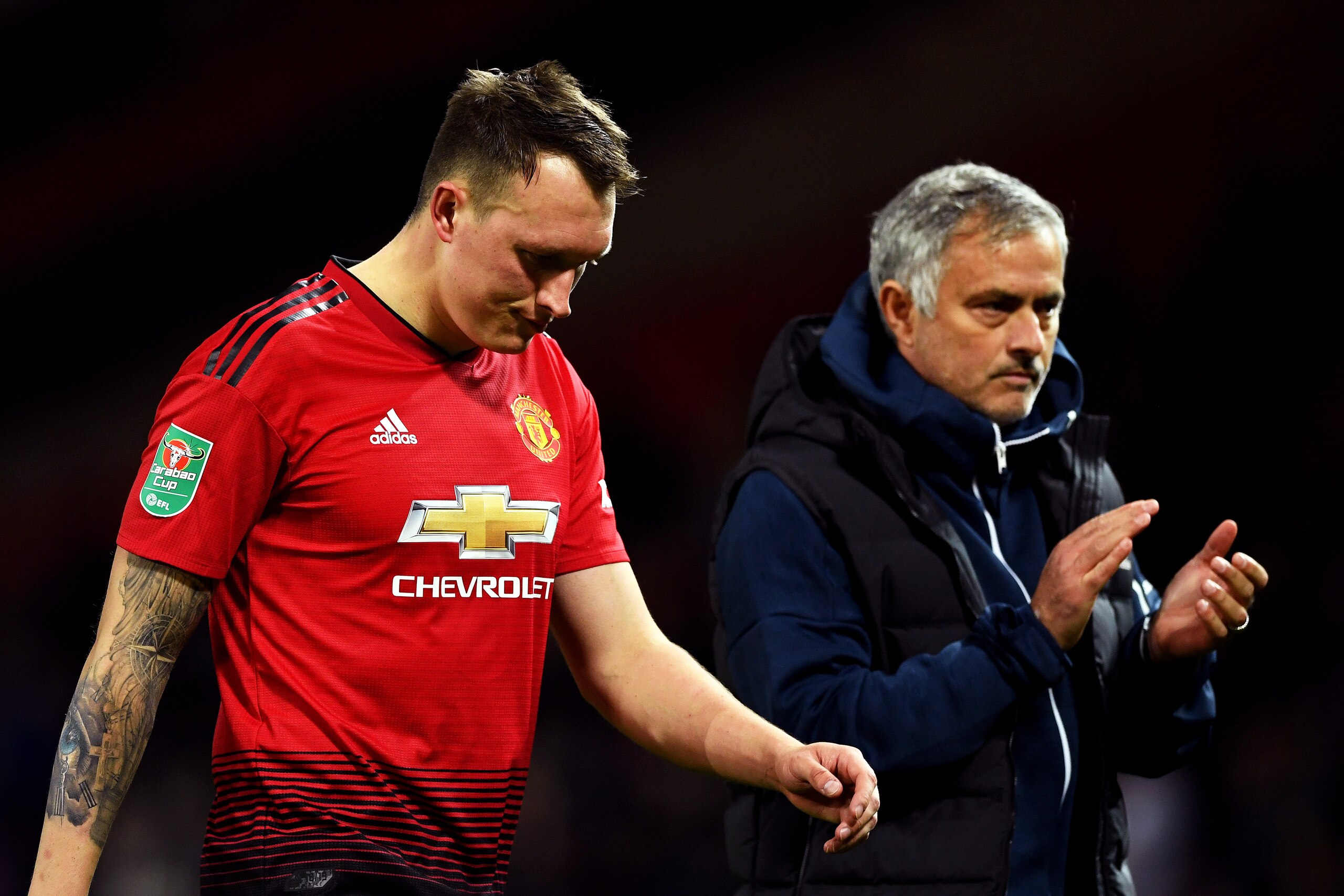 MANCHESTER, ENGLAND - SEPTEMBER 25:  Jose Mourinho, Manager of Manchester United applauds fans as Phil Jones of Manchester United looks dejected after missing his team's eighth penalty, meaning Derby County win the match on penalties during the Carabao Cu