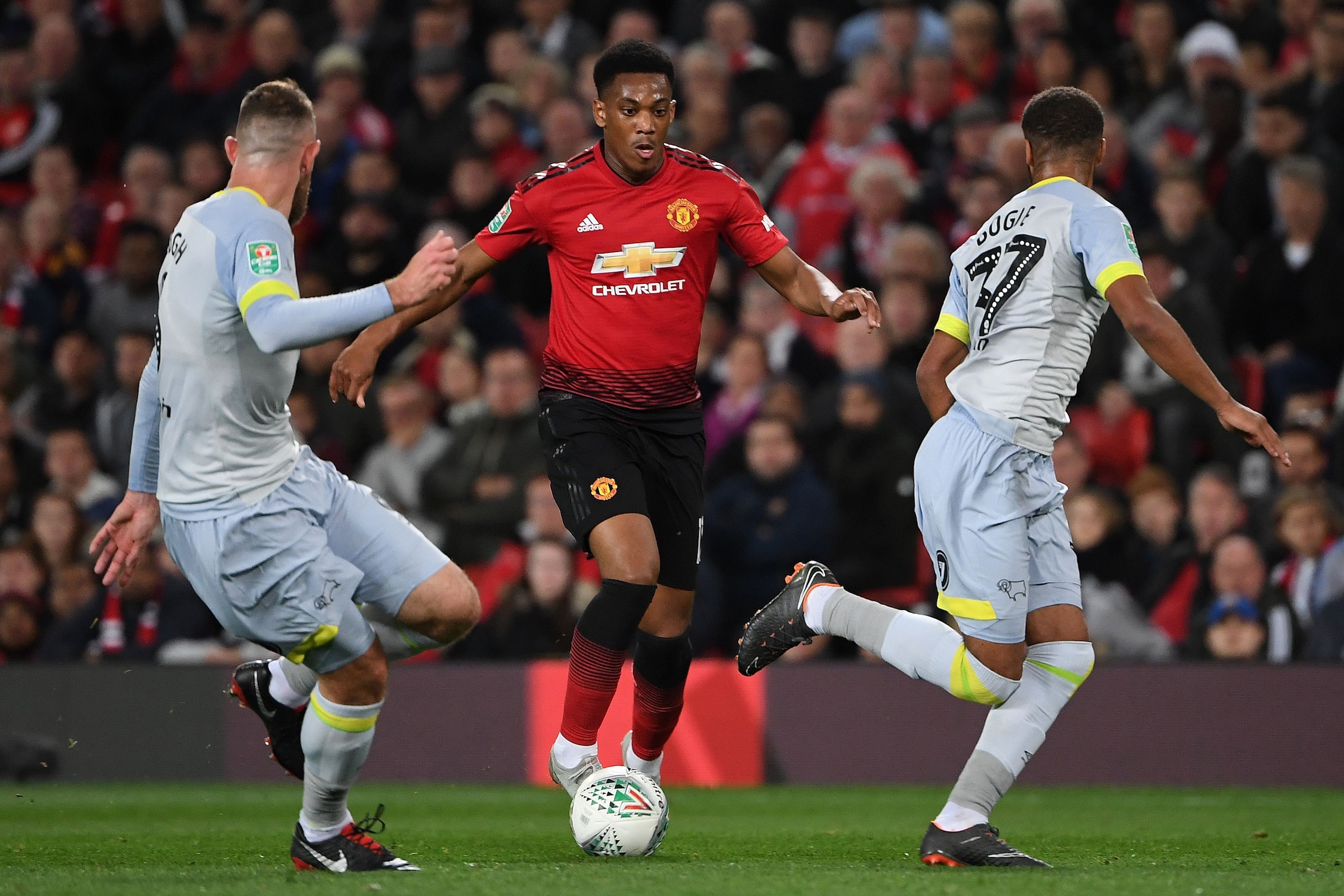 Manchester United's French striker Anthony Martial (L) vies with Derby's English-born Irish defender Richard Keogh (L) and Derby's English defender Jayden Bogle during the English League Cup third round football match between Manchester United and Derby C