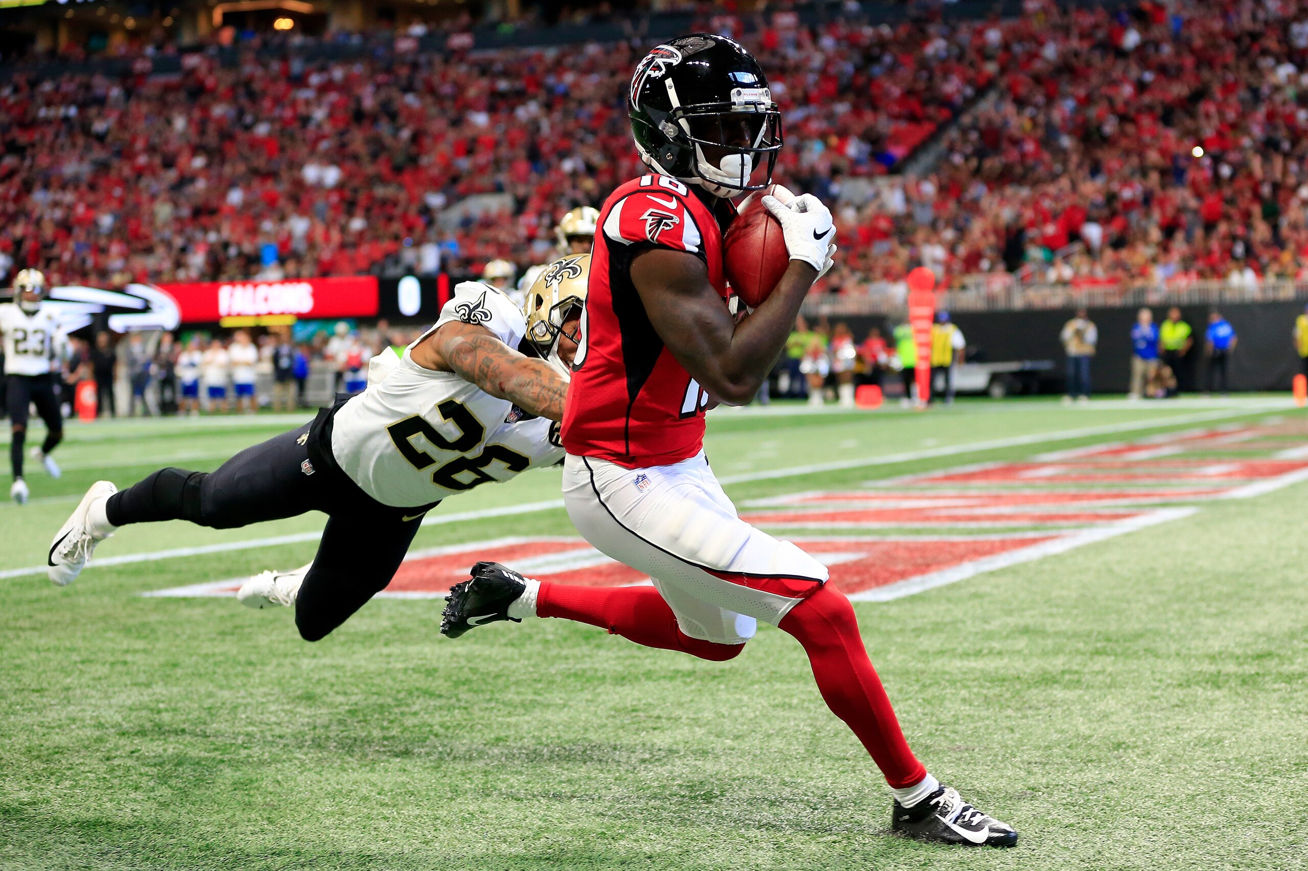 ATLANTA, GA - SEPTEMBER 23: Calvin Ridley #18 of the Atlanta Falcons catches a touchdown pass over P.J. Williams #26 of the New Orleans Saints during the first half at Mercedes-Benz Stadium on September 23, 2018 in Atlanta, Georgia. (Photo by Daniel Shire ATLANTA, GA - SEPTEMBER 23: Calvin Ridley #18 of the Atlanta Falcons catches a touchdown pass over P.J. Williams #26 of the New Orleans Saints during the first half at Mercedes-Benz Stadium on September 23, 2018 in Atlanta, Georgia. (Photo by Daniel Shire