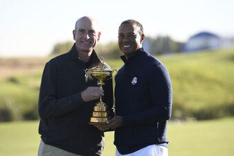 US team captain Jim Furyk (L) and US golfer Tiger Woods pose with the Ryder Cup after a team photograph ahead of the 42nd Ryder Cup at Le Golf National Course at Saint-Quentin-en-Yvelines, south-west of Paris on September 26, 2018. (Photo by Eric FEFERBER