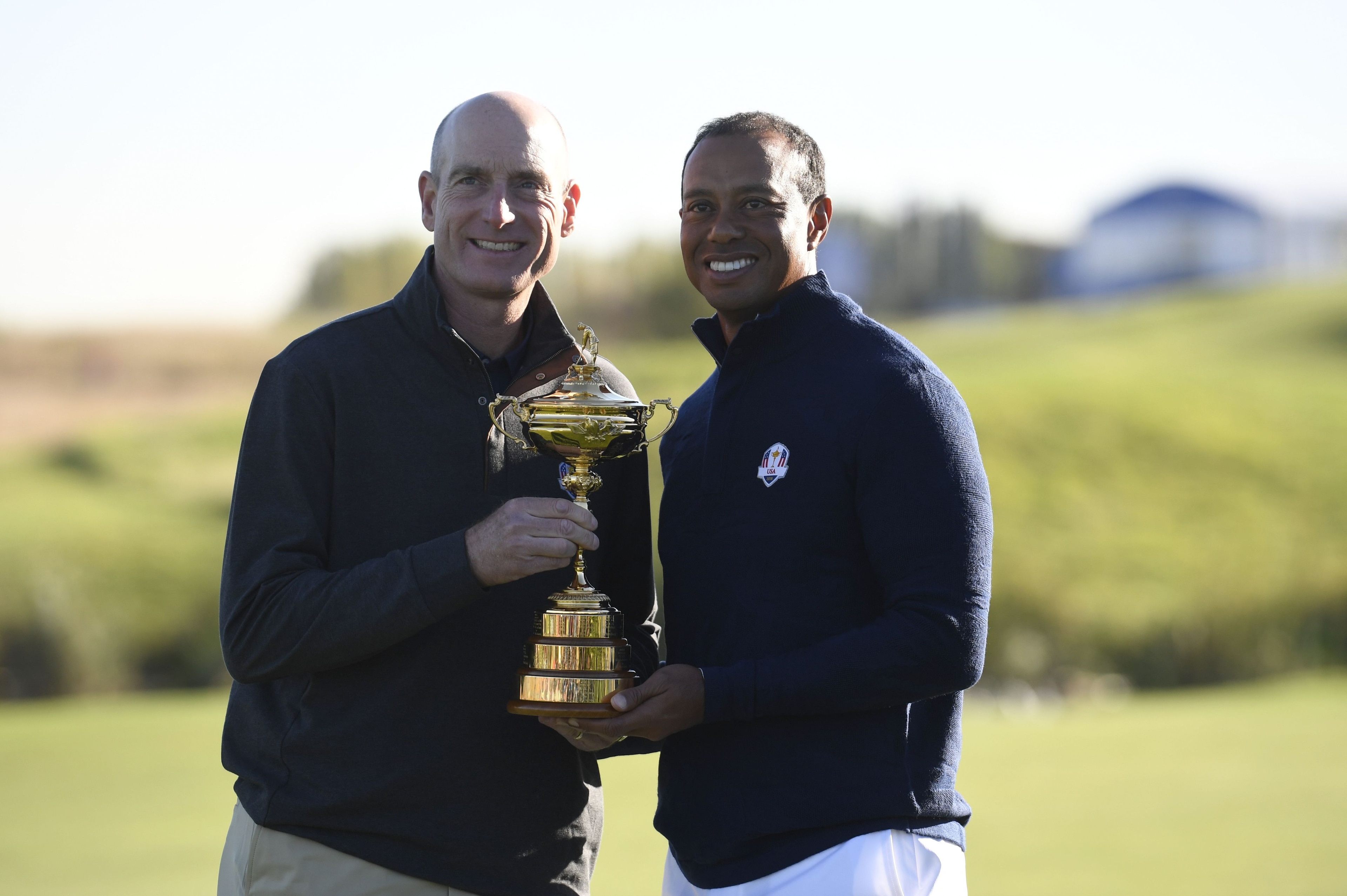 US team captain Jim Furyk (L) and US golfer Tiger Woods pose with the Ryder Cup after a team photograph ahead of the 42nd Ryder Cup at Le Golf National Course at Saint-Quentin-en-Yvelines, south-west of Paris on September 26, 2018. (Photo by Eric FEFERBER