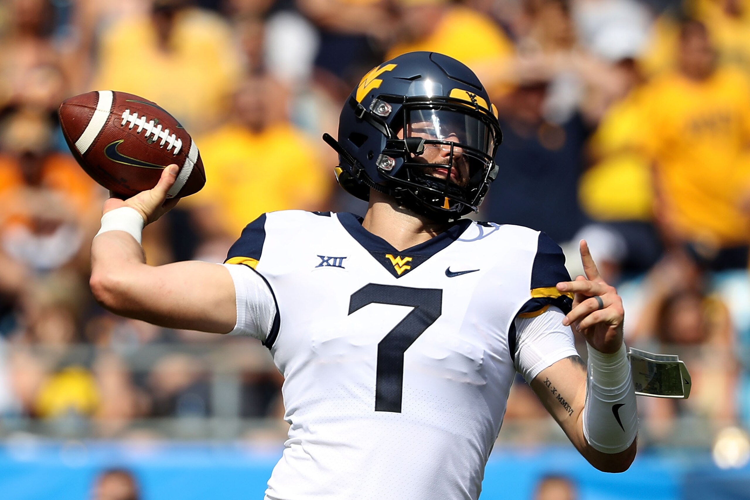 CHARLOTTE, NC - SEPTEMBER 01:  Will Grier #7 of the West Virginia Mountaineers drops back to pass against the Tennessee Volunteers during their game at Bank of America Stadium on September 1, 2018 in Charlotte, North Carolina.  (Photo by Streeter Lecka/Ge