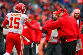 DENVER, CO - DECEMBER 31:  Head coach Andy Reid of the Kansas City Chiefs celebrates with quarterback Patrick Mahomes #15 after the Kansas City Chiefs offense scored a touchdown against the Denver Broncosat Sports Authority Field at Mile High on December 