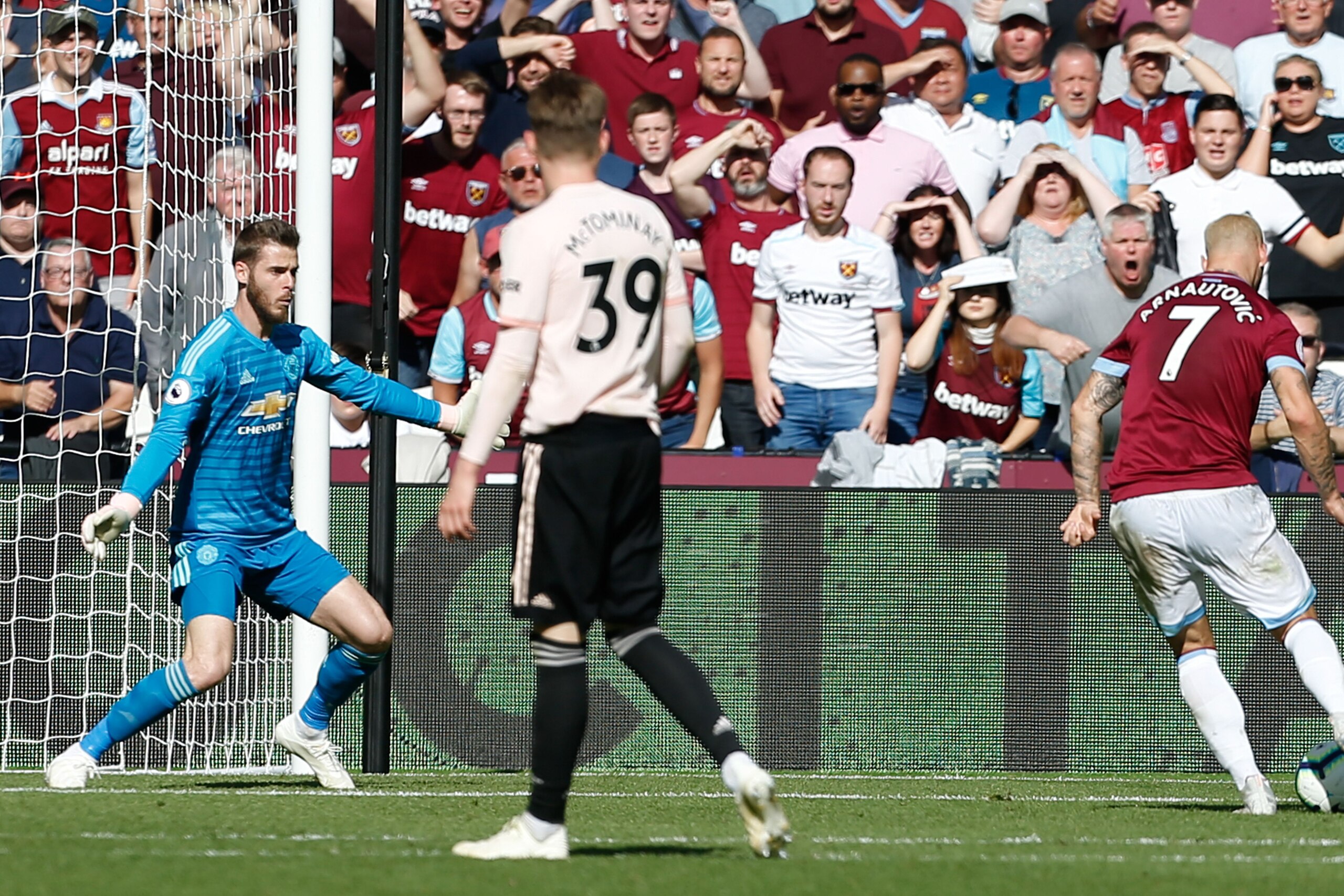 West Ham United's Austrian midfielder Marko Arnautovic (R) scores their third goal past Manchester United's Spanish goalkeeper David de Gea (L) during the English Premier League football match between West Ham United and Manchester United at The London St
