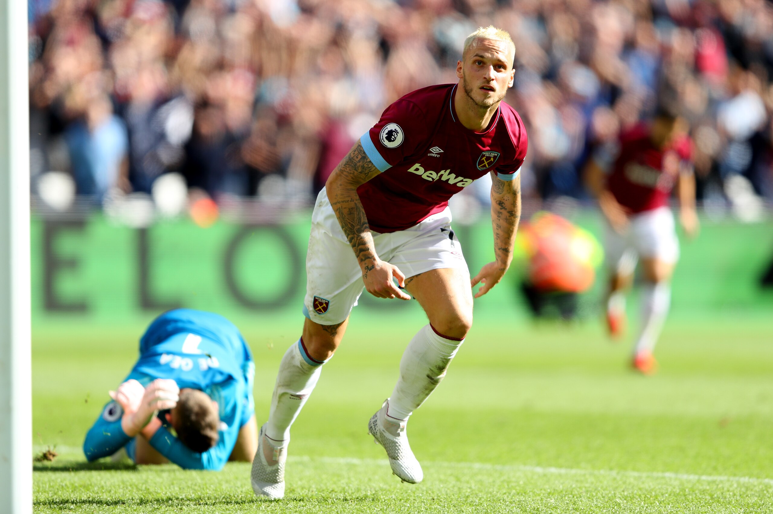 LONDON, ENGLAND - SEPTEMBER 29:  Marko Arnautovic of West Ham United runs past David De Gea of Manchester United to celebrate after scoring his sides third goal during the Premier League match between West Ham United and Manchester United at London Stadiu