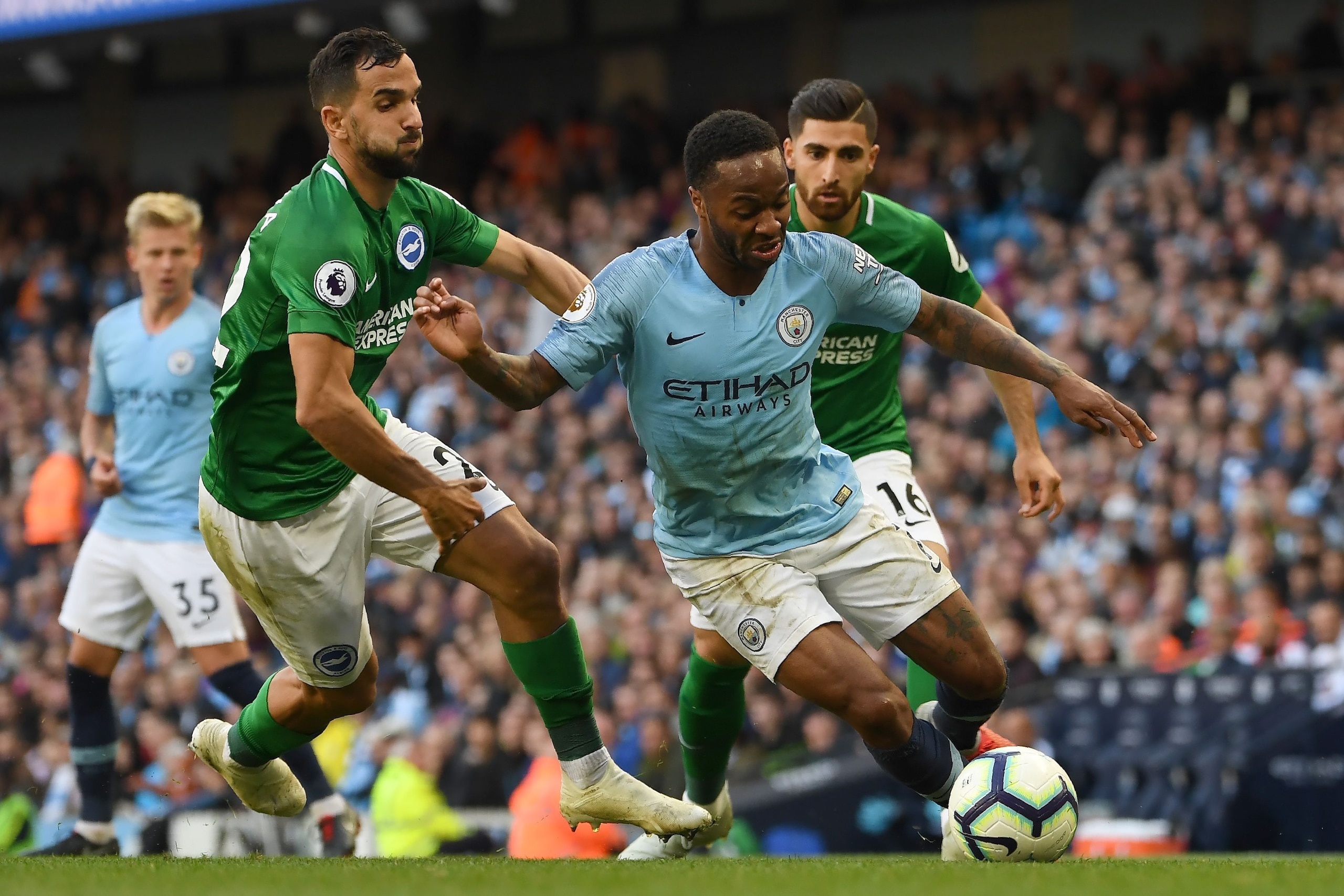 Manchester City's English midfielder Raheem Sterling (R) vies with Brighton's Spanish defender Martin Montoya during the English Premier League football match between Manchester City and Brighton and Hove Albion at the Etihad Stadium in Manchester, north 