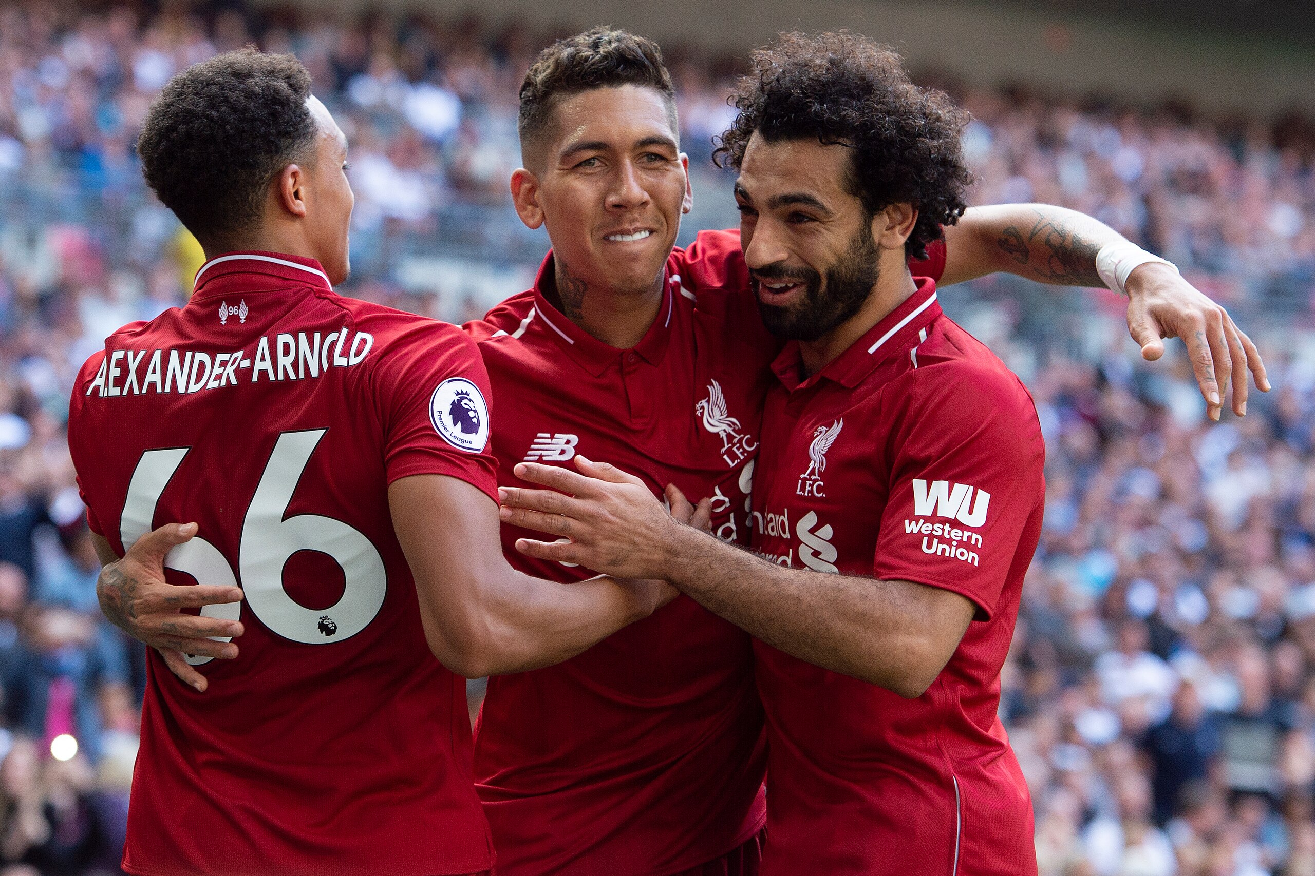 LONDON, ENGLAND - SEPTEMBER 15: Roberto Firmino of Liverpool celebrates his goal with Trent Alexander-Arnold and Mohamed Salah during the Premier League match between Tottenham Hotspur and Liverpool FC at Wembley Stadium on September 15, 2018 in London, U